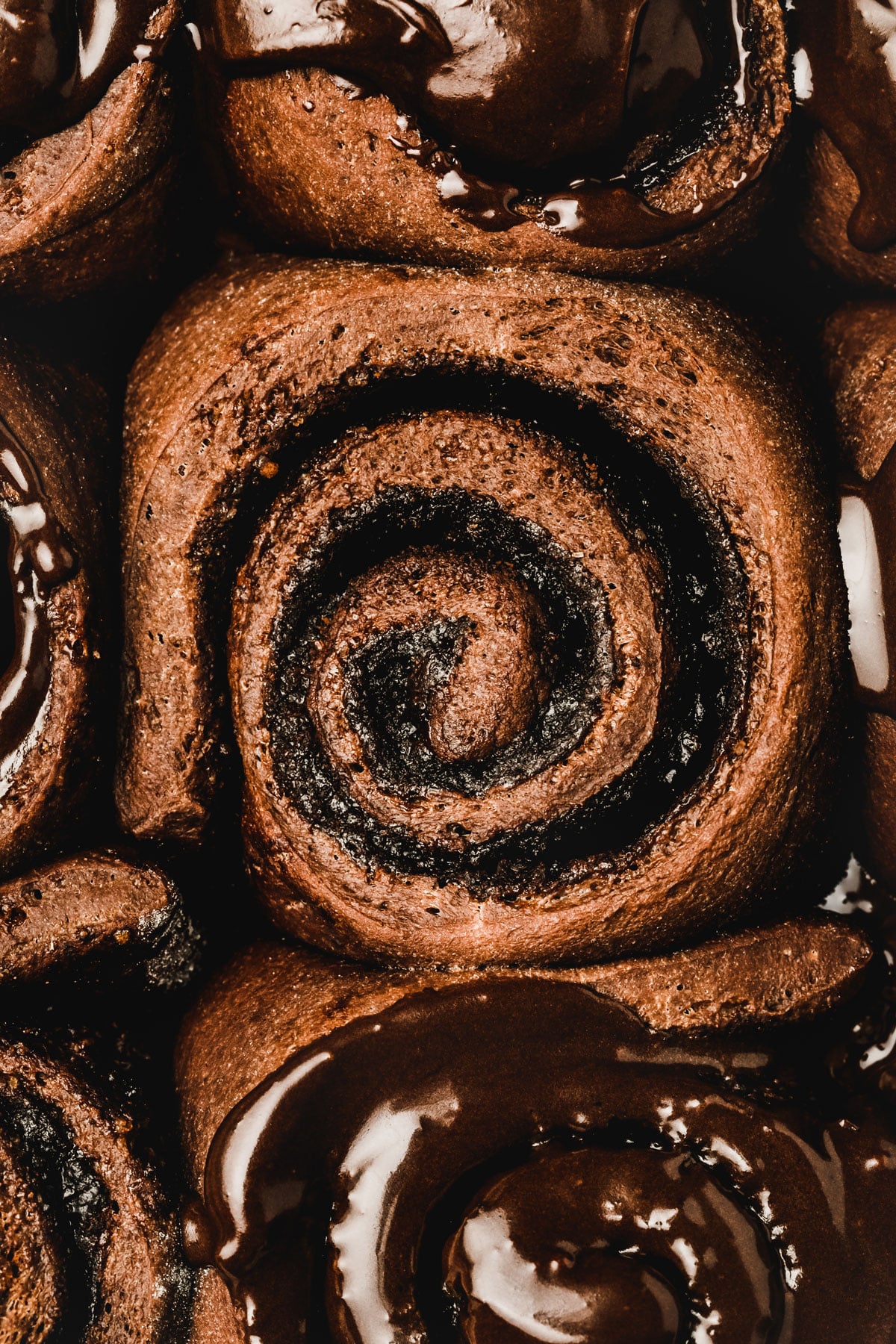 Chocolate cinnamon roll topped with chocolate glaze