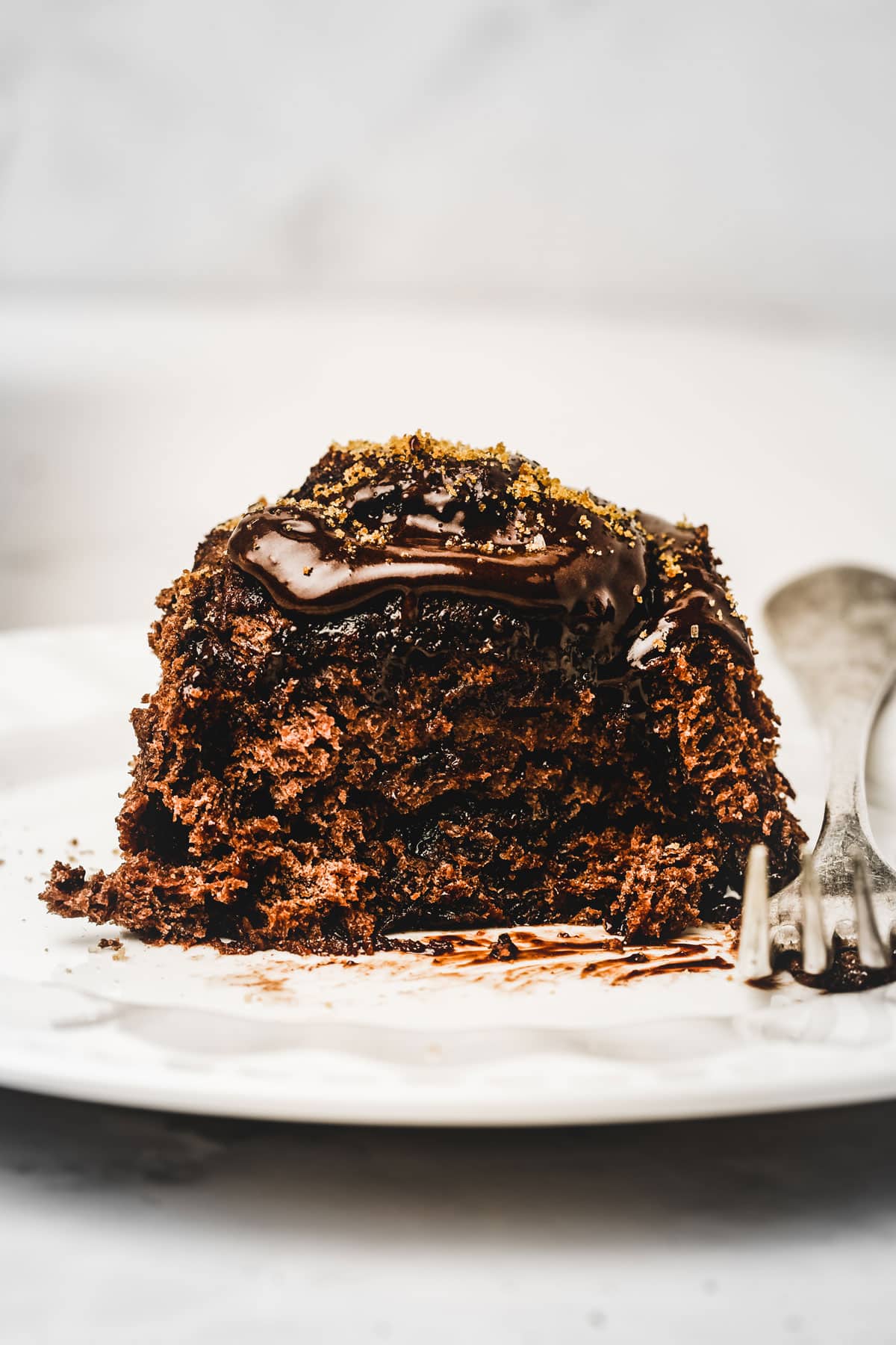 Chocolate cinnamon roll on a plate with a fork