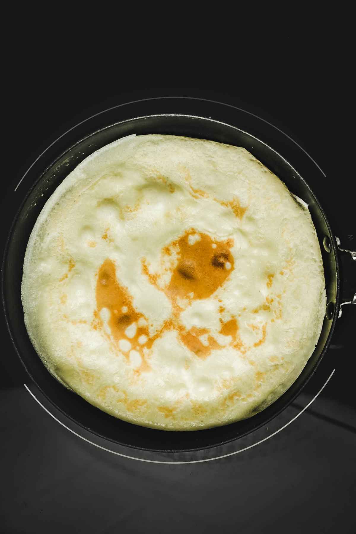 Crepe pan with a baked crepe