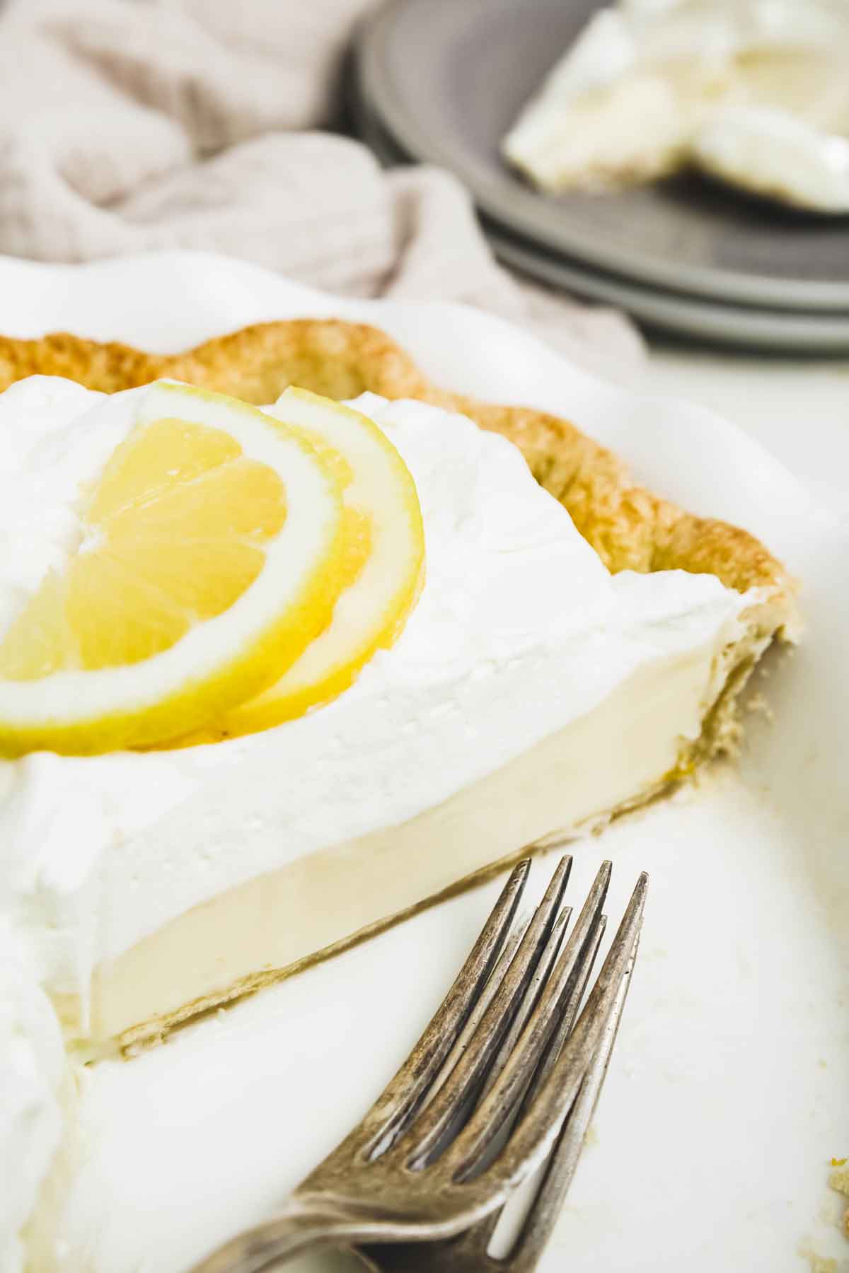 lemon cream pie with condensed milk sliced in the pie dish
