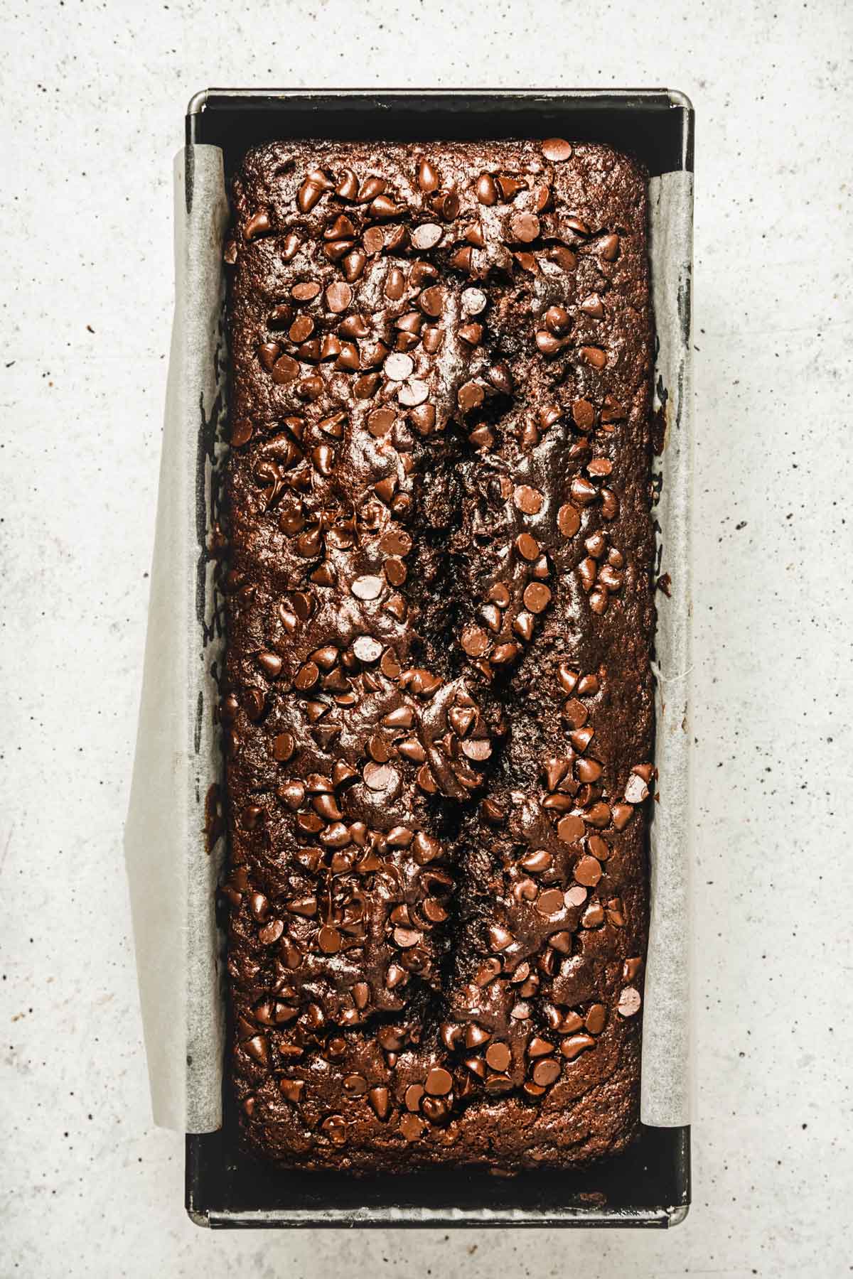 loaf pan with baked chocolate banana bread