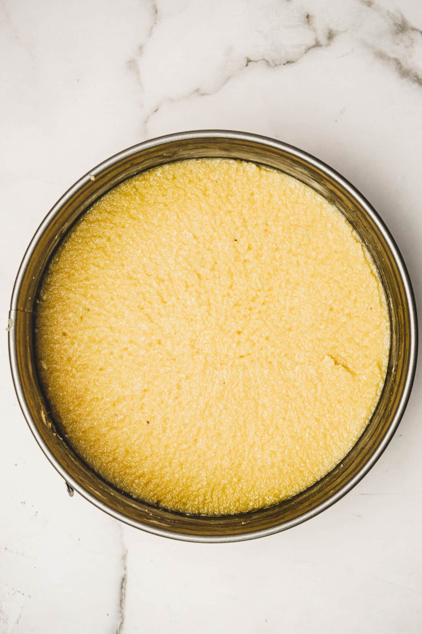 Springform pan with almond cake batter