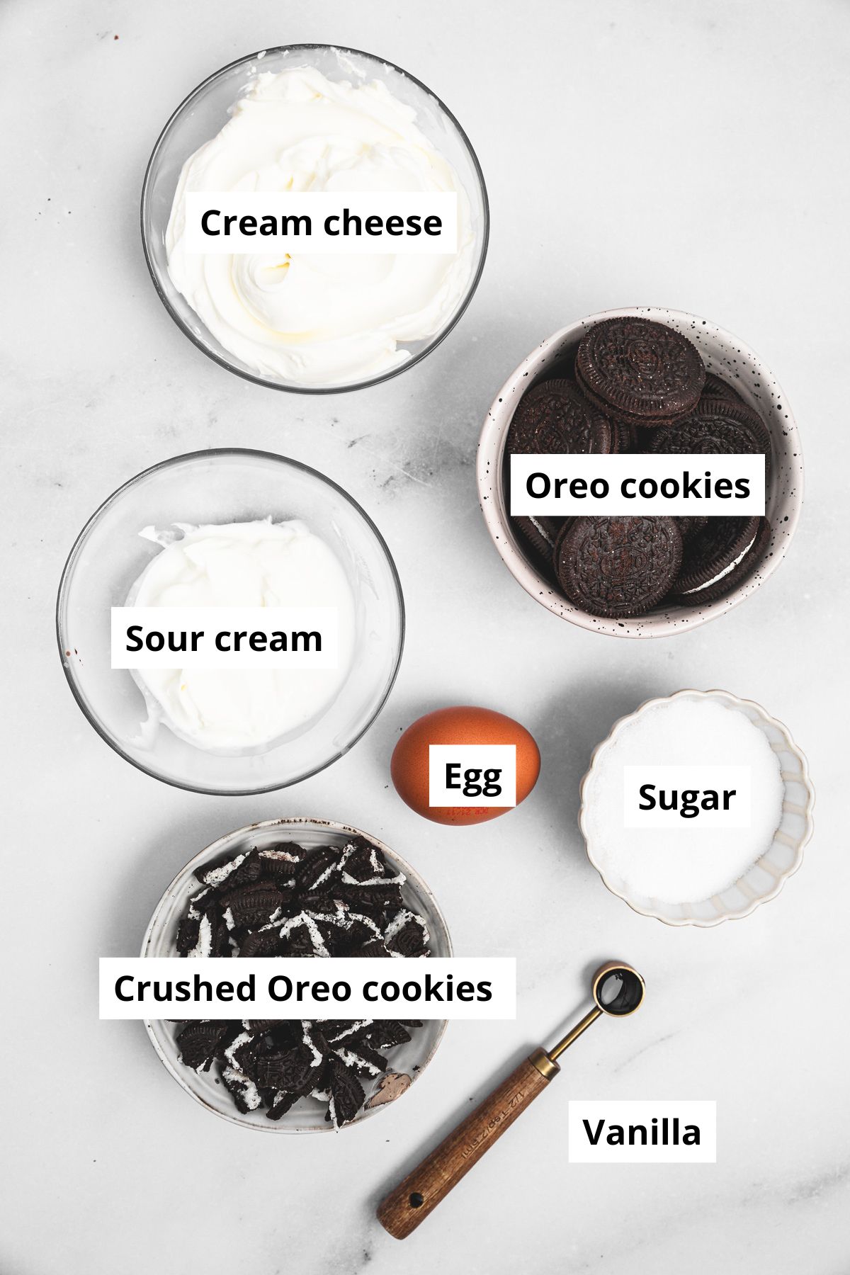 ingredients for mini oreo cheesecakes in small bowls