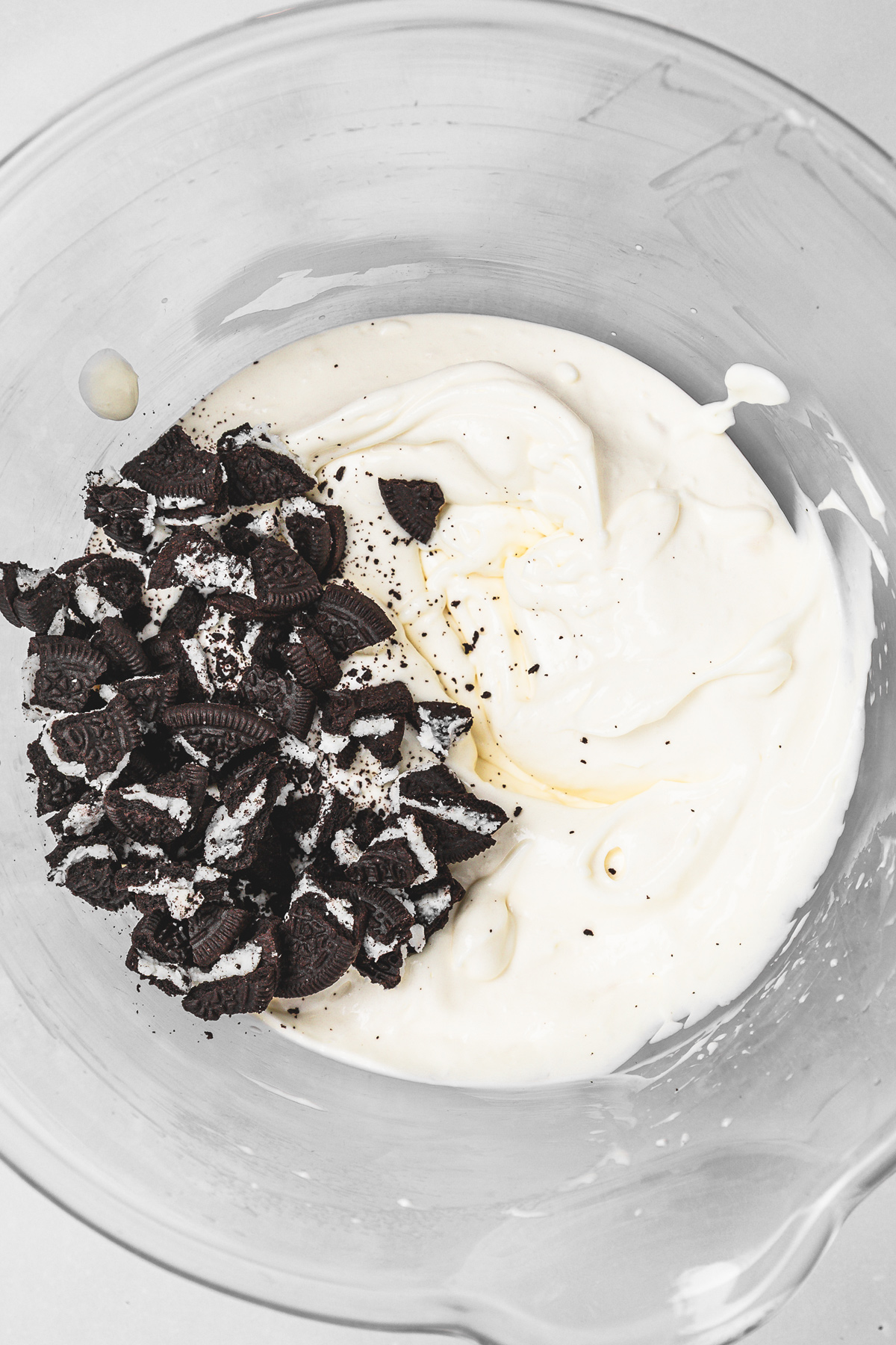 bowl with oreo cheesecake batter and crushed oreo cookies