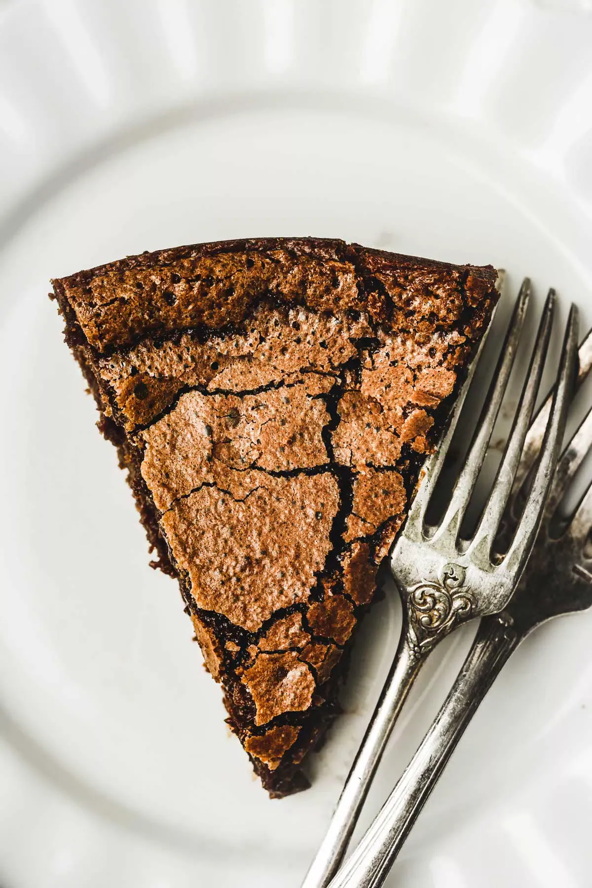 Slice of chocolate fondant on a plate with forks