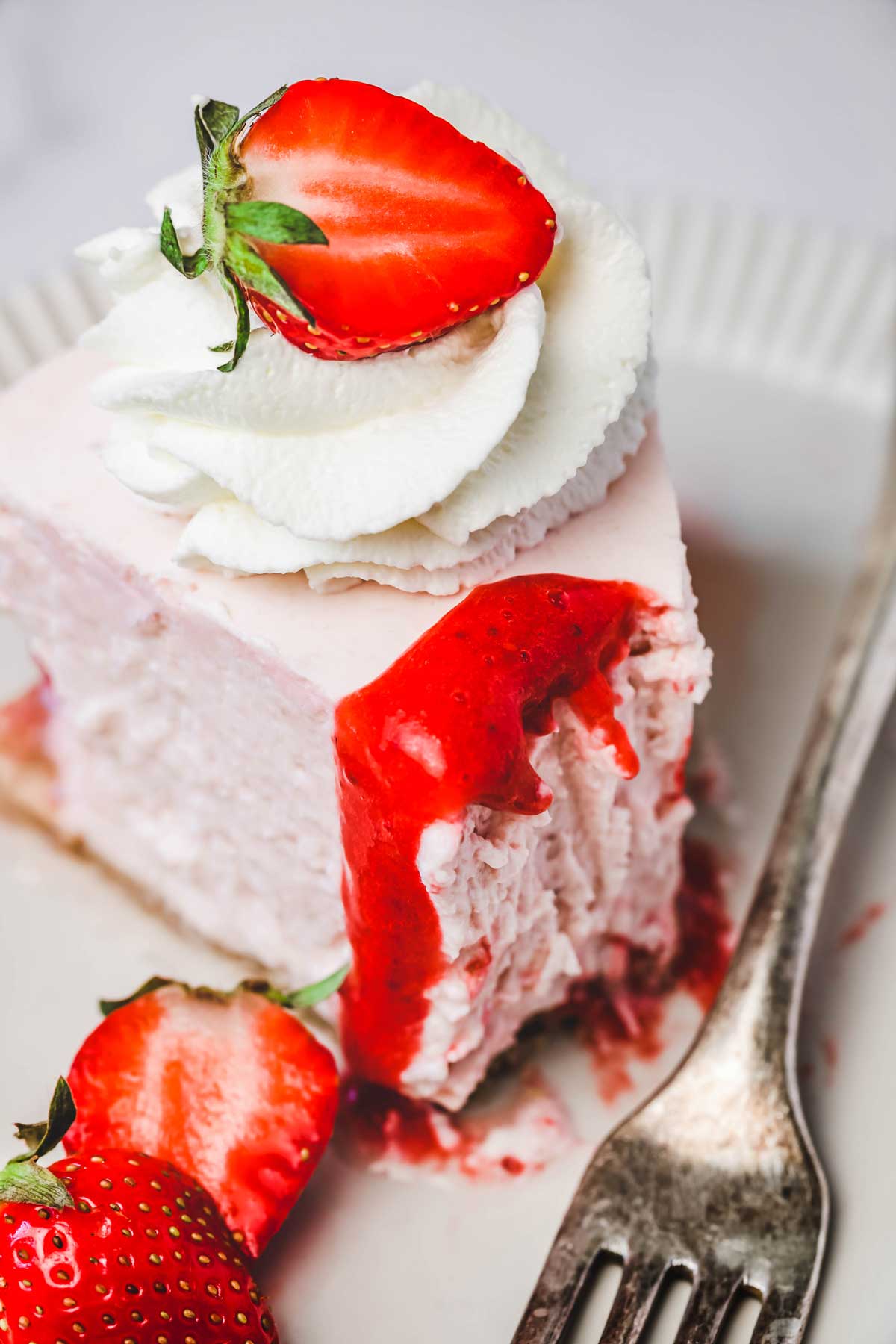 Strawberry cheesecake slice with fork