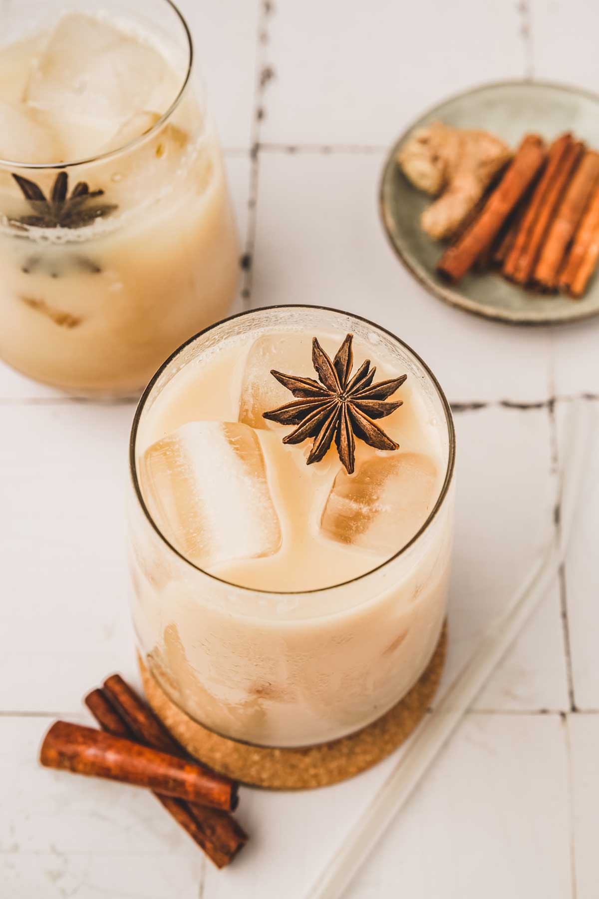 Iced chai tea latte in a glass with spices