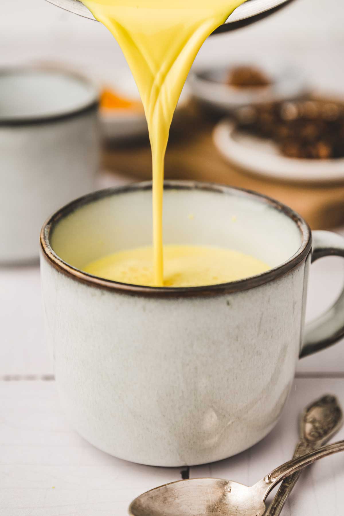 Turmeric-infused milk poured into a cup