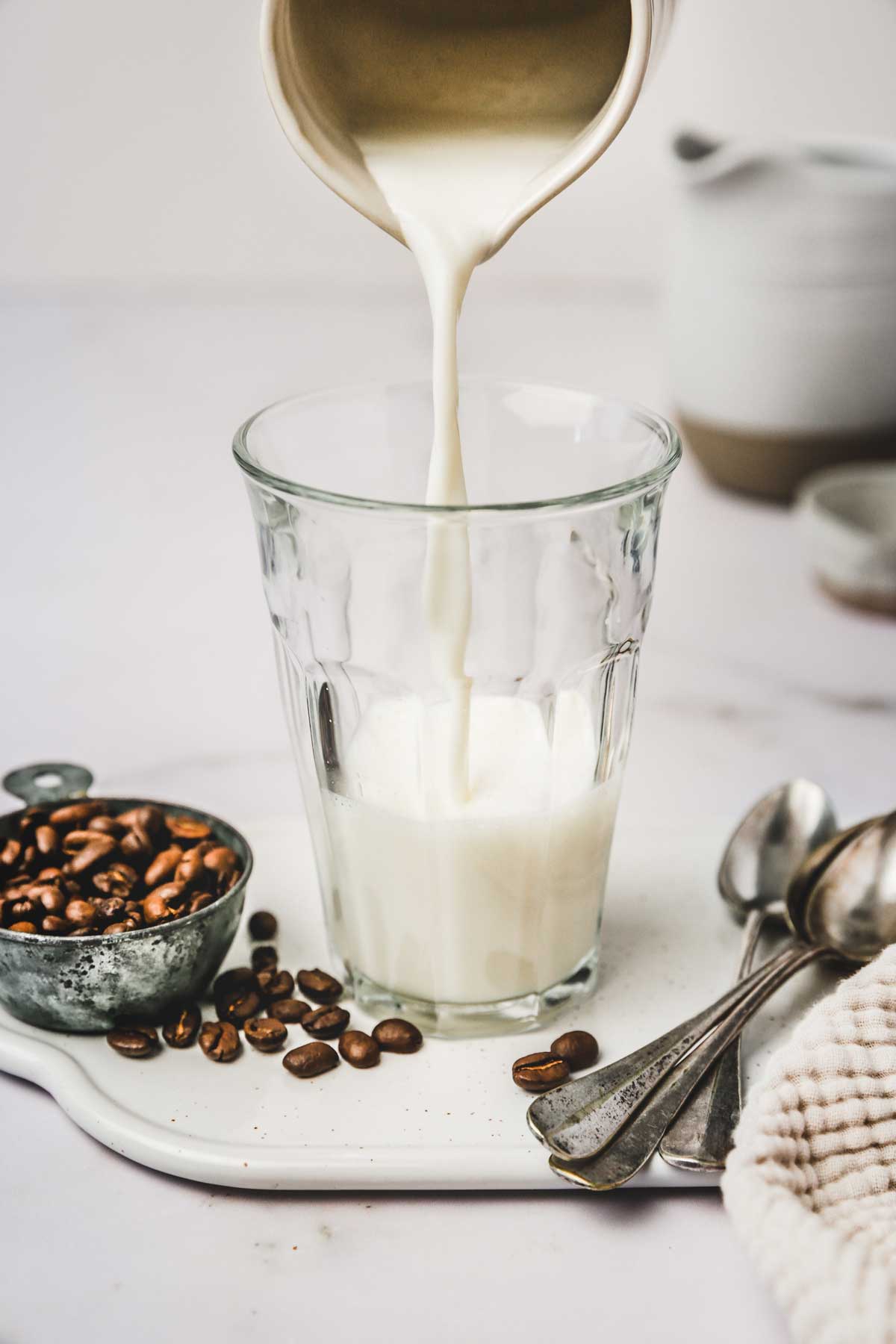 Milk flowing in a transparent glass