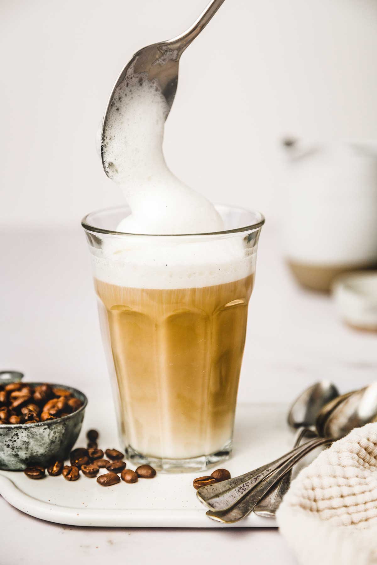 Milk foam put on the cup filled with coffee with milk