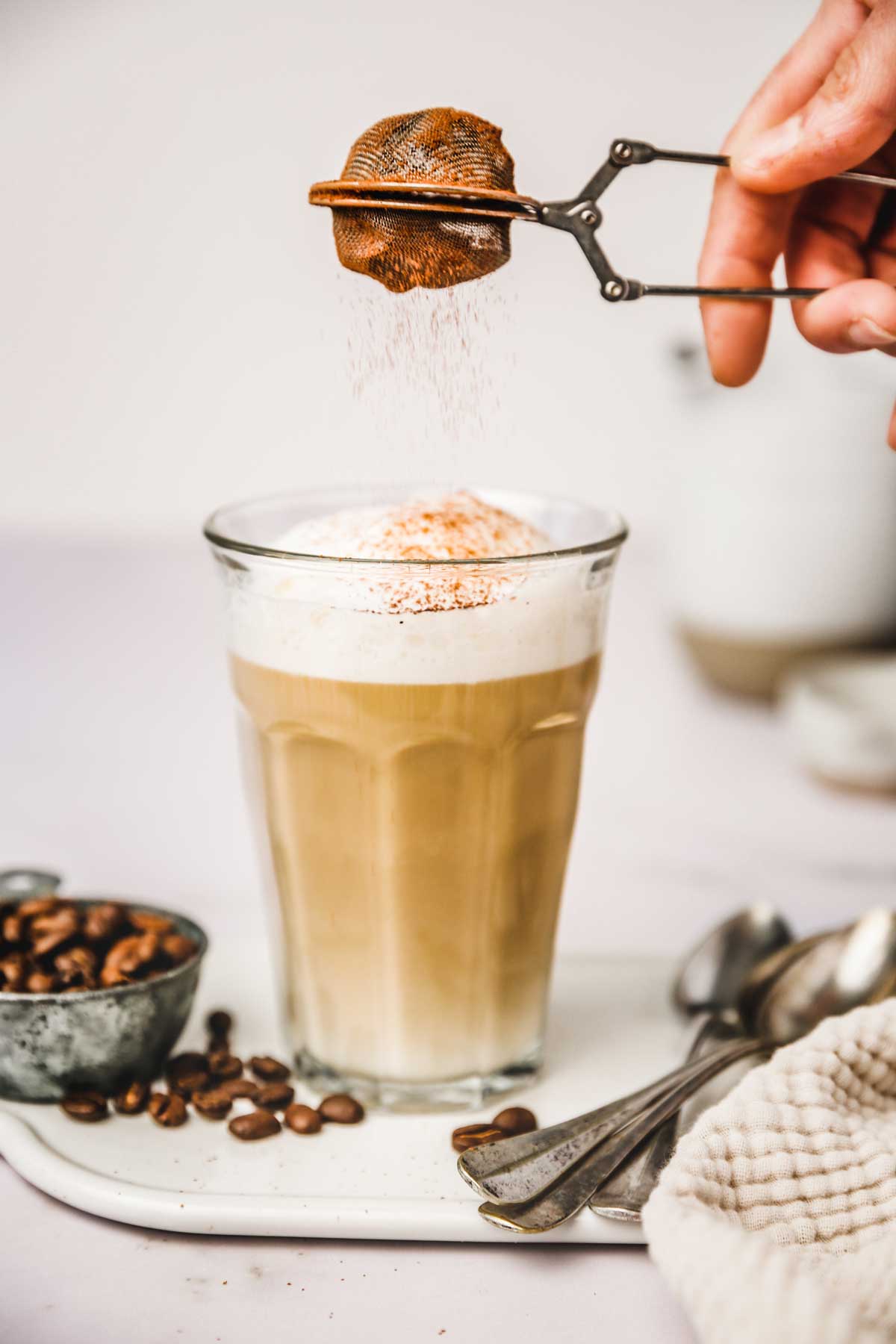 Cocoa powder sprinkled on a cup of latte