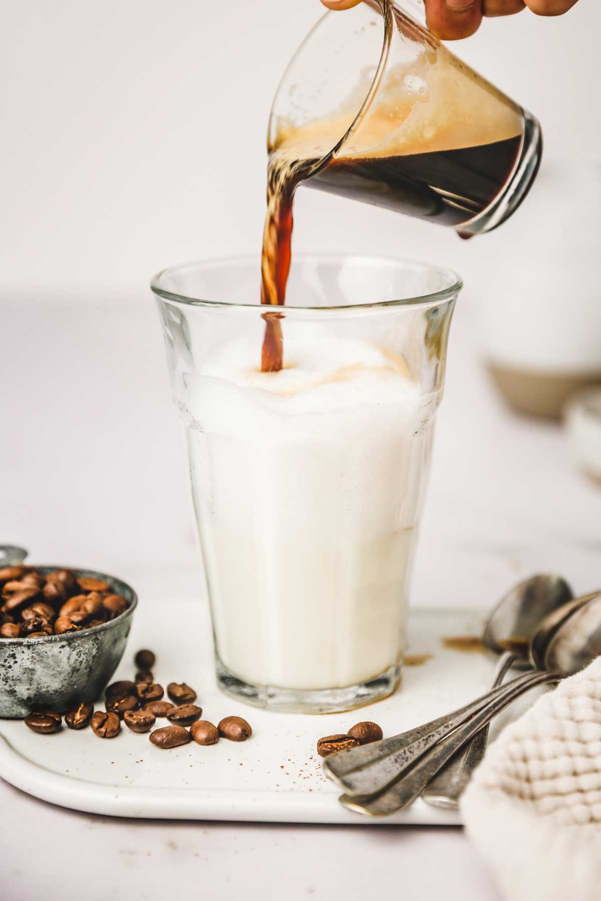 coffee flowing in a glass of milk