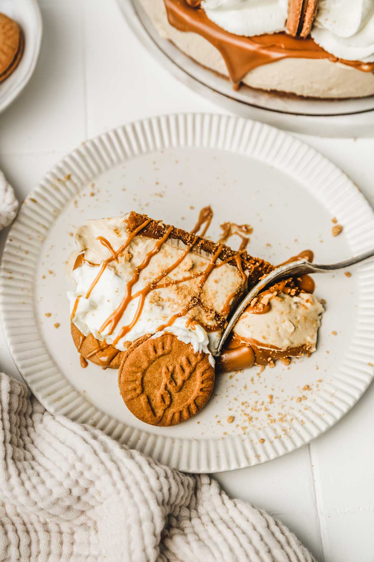 slice of cookie butter cheeescake on a dessert plate