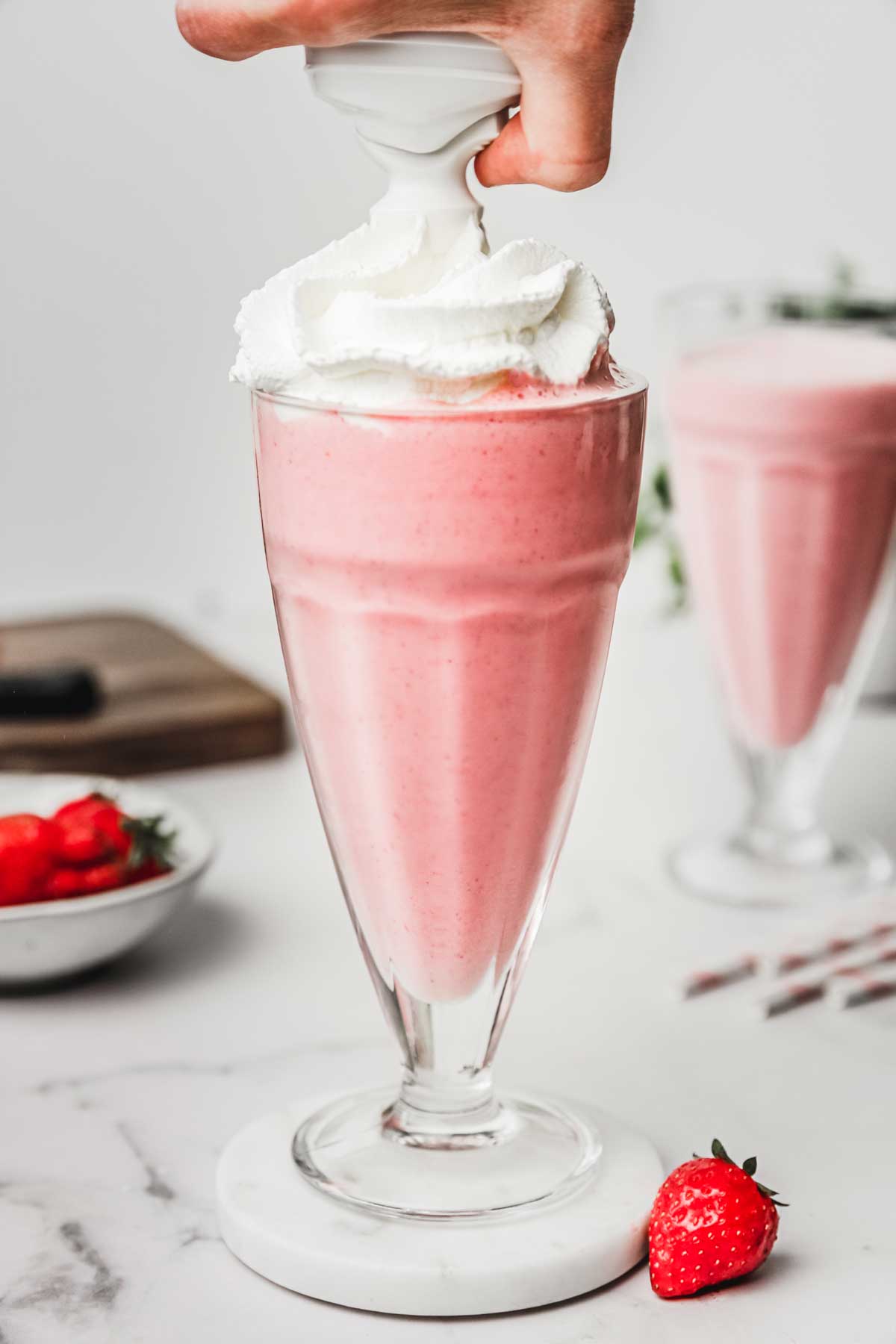 Glass with milkshake and whipped cream