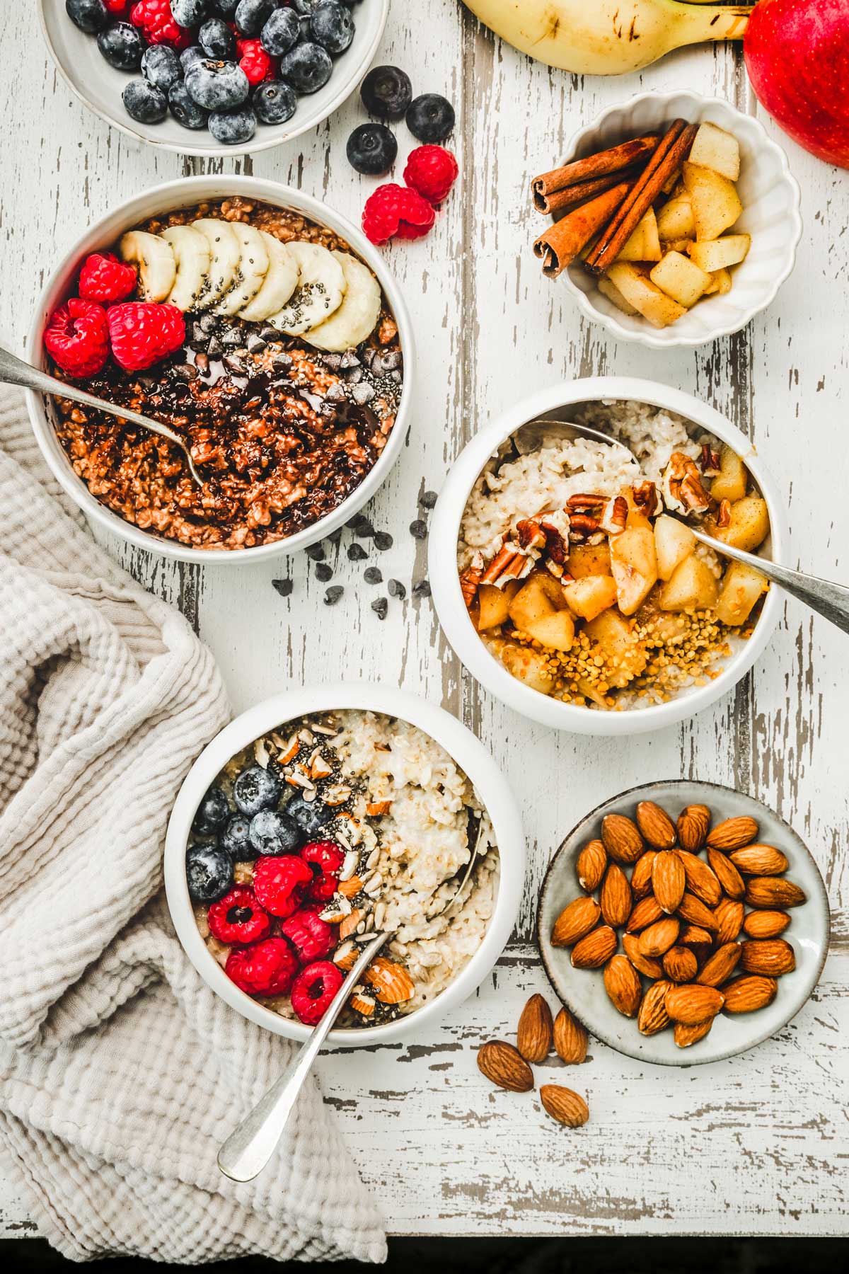 Table with bowl, oatmeal porridge and fruits