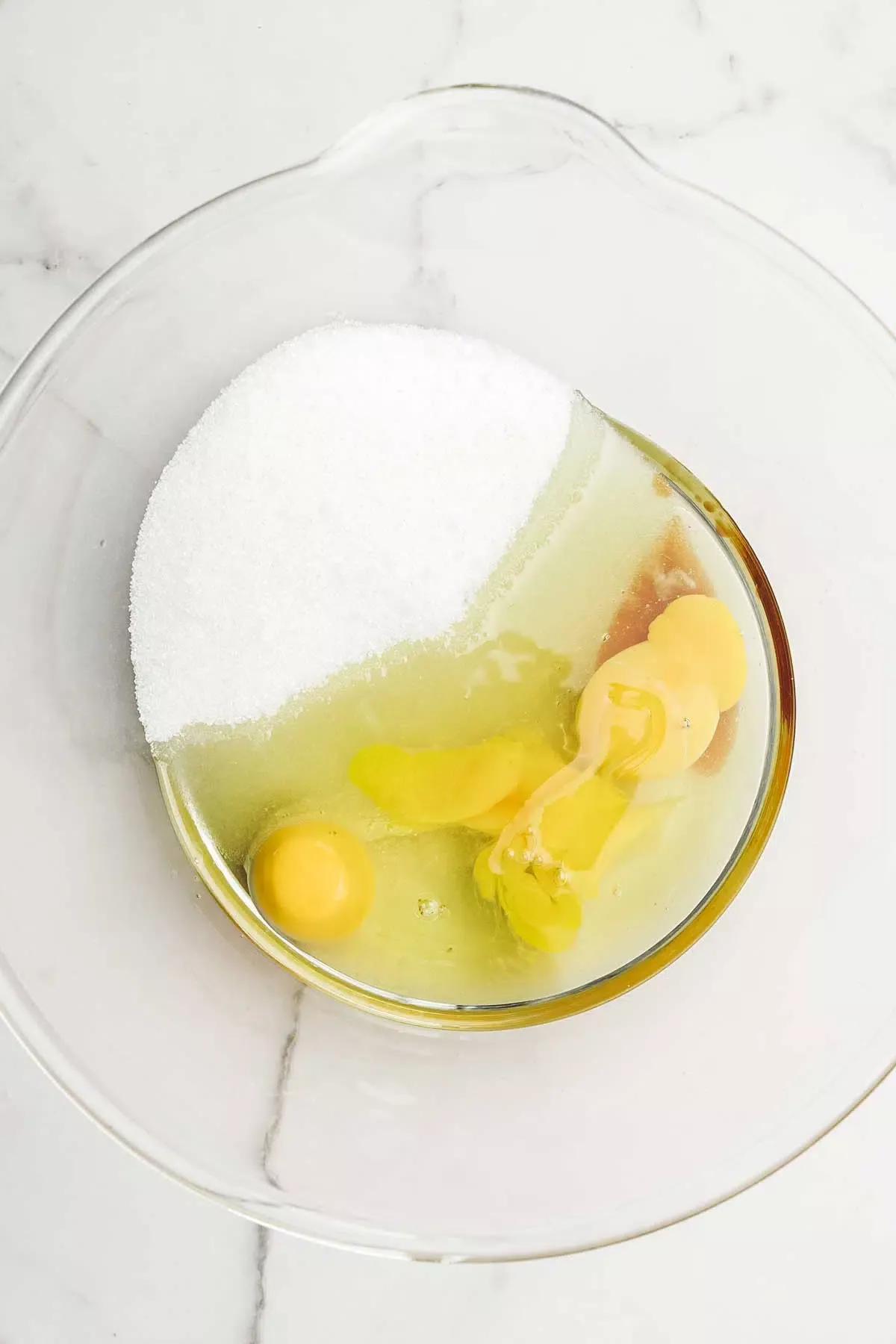 large mixing bowl with egg and sugar