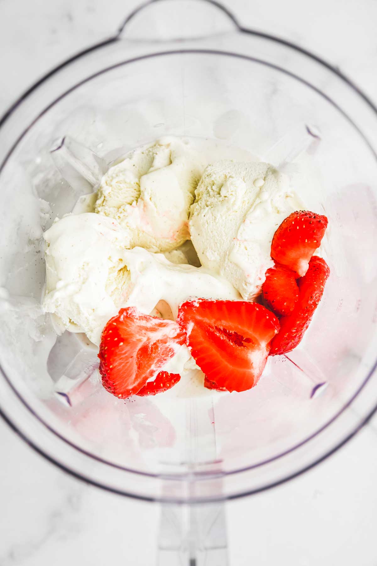 Bowl with ice, strawberry and milk
