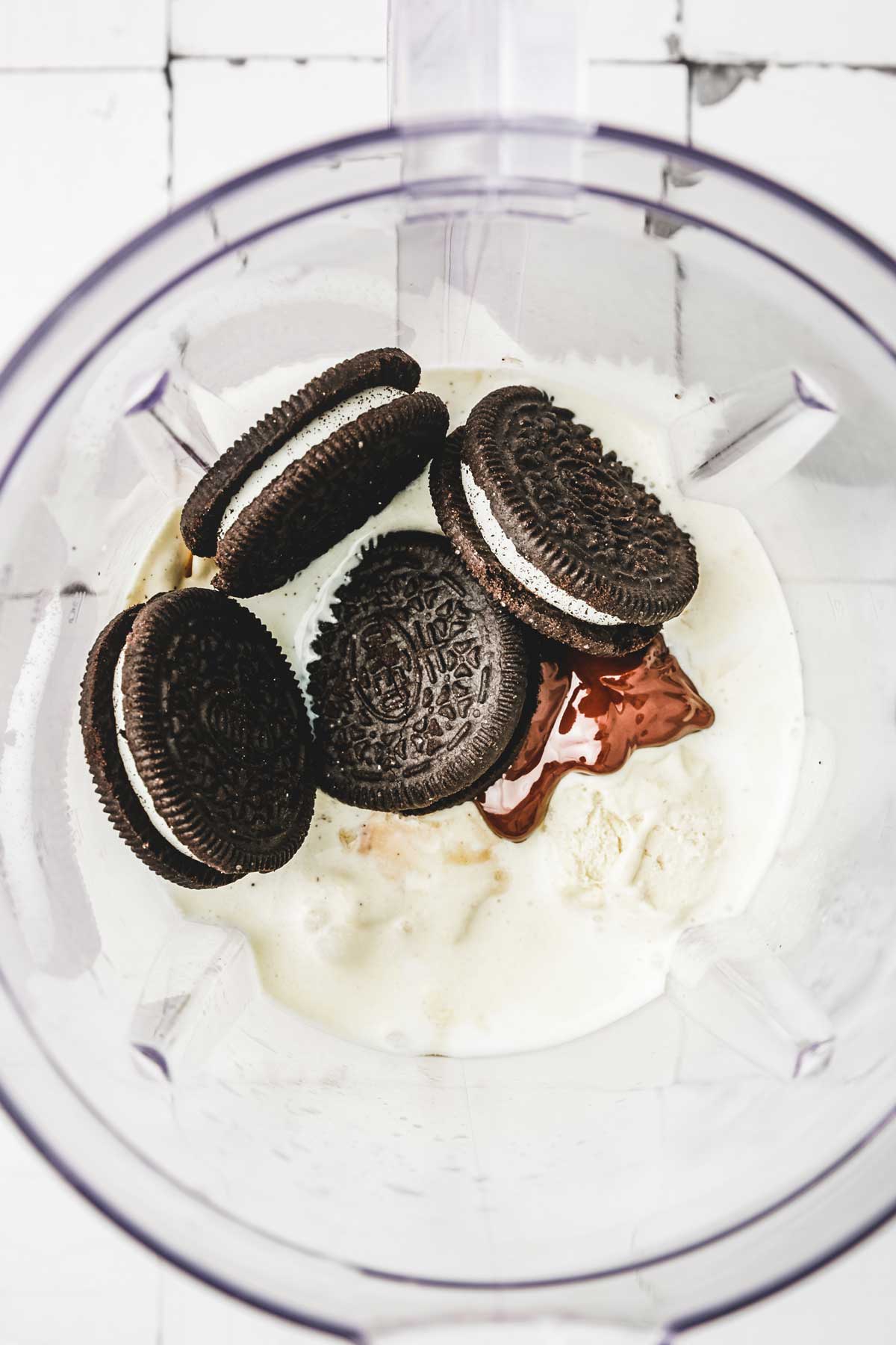 Mixer bowl with ingredients and oreo cookies