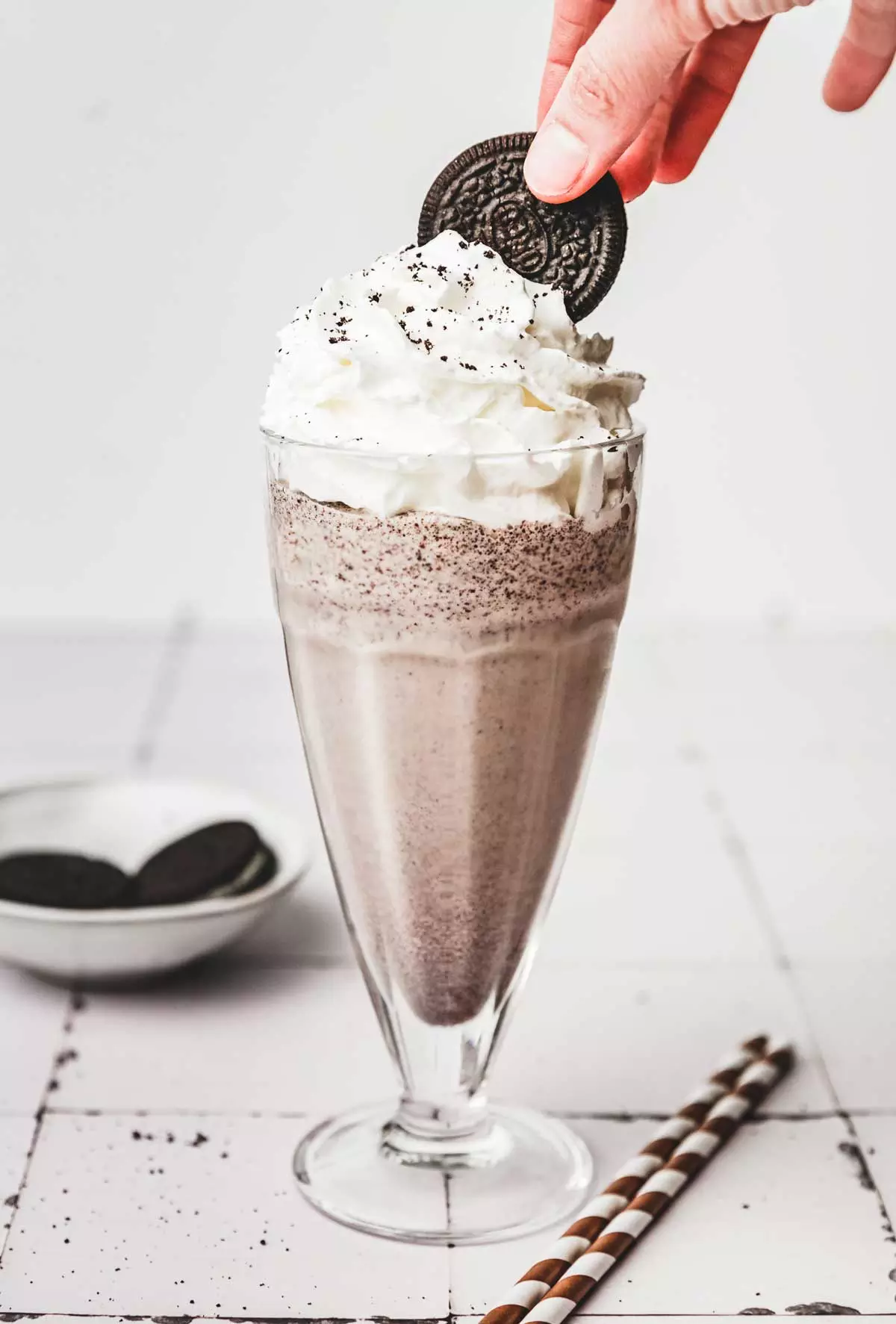 Oreo cookie on a milkshake with whipped cream