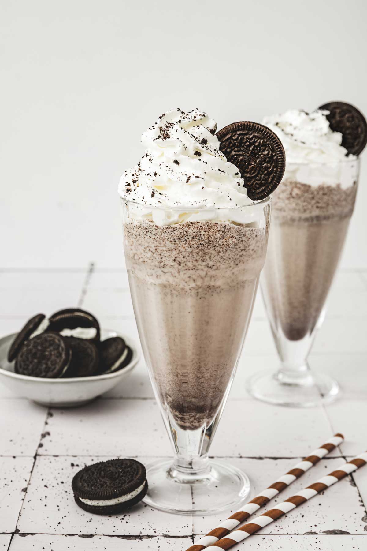 2 glasses of oreo milkshake on a table