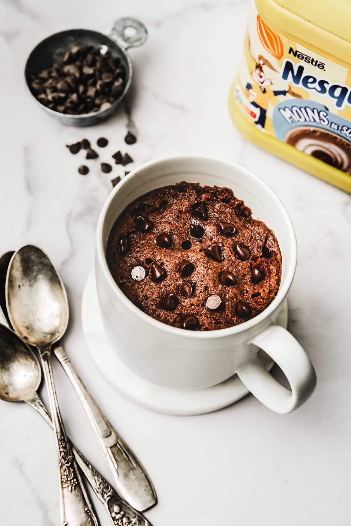 Hot cocoa mug cake with chocolate chips in a white mug