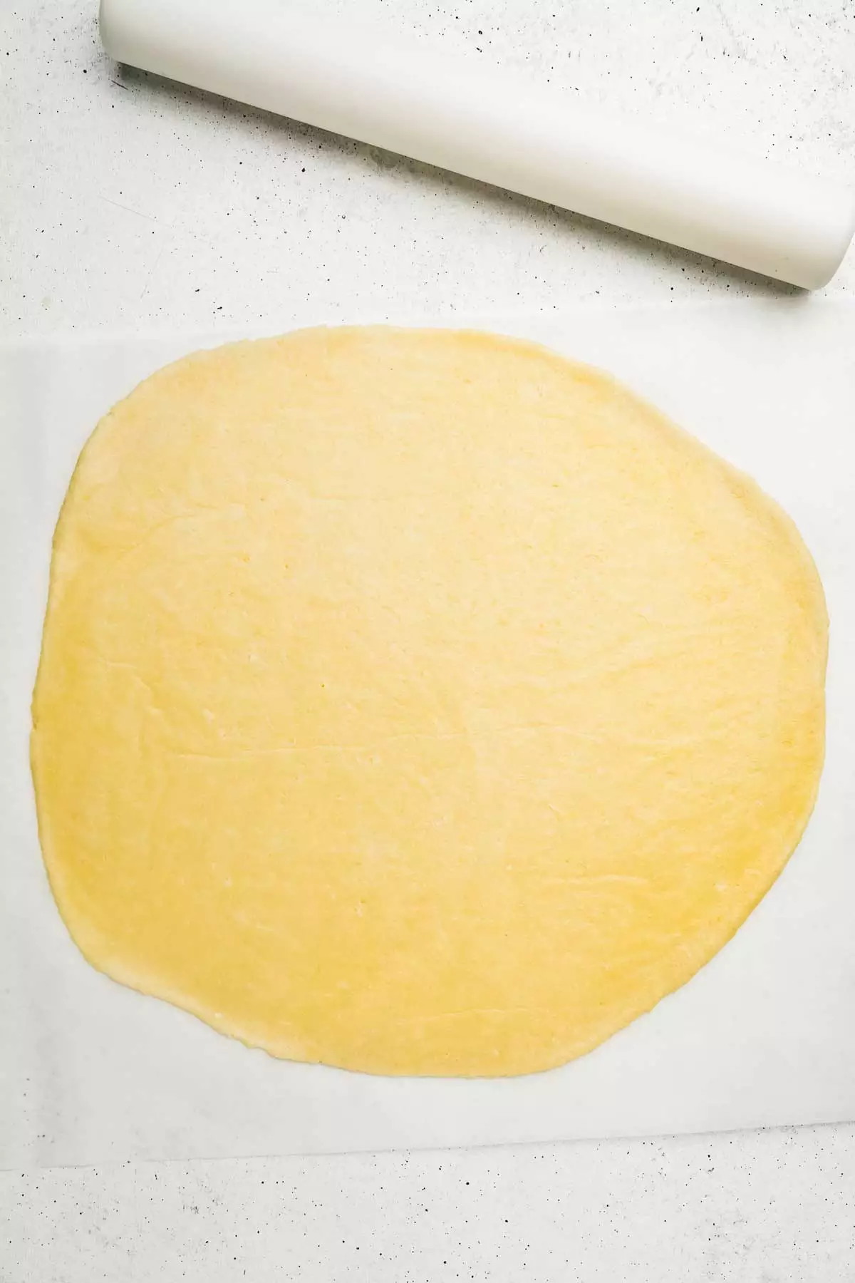 Pie crust spread out on a work surface