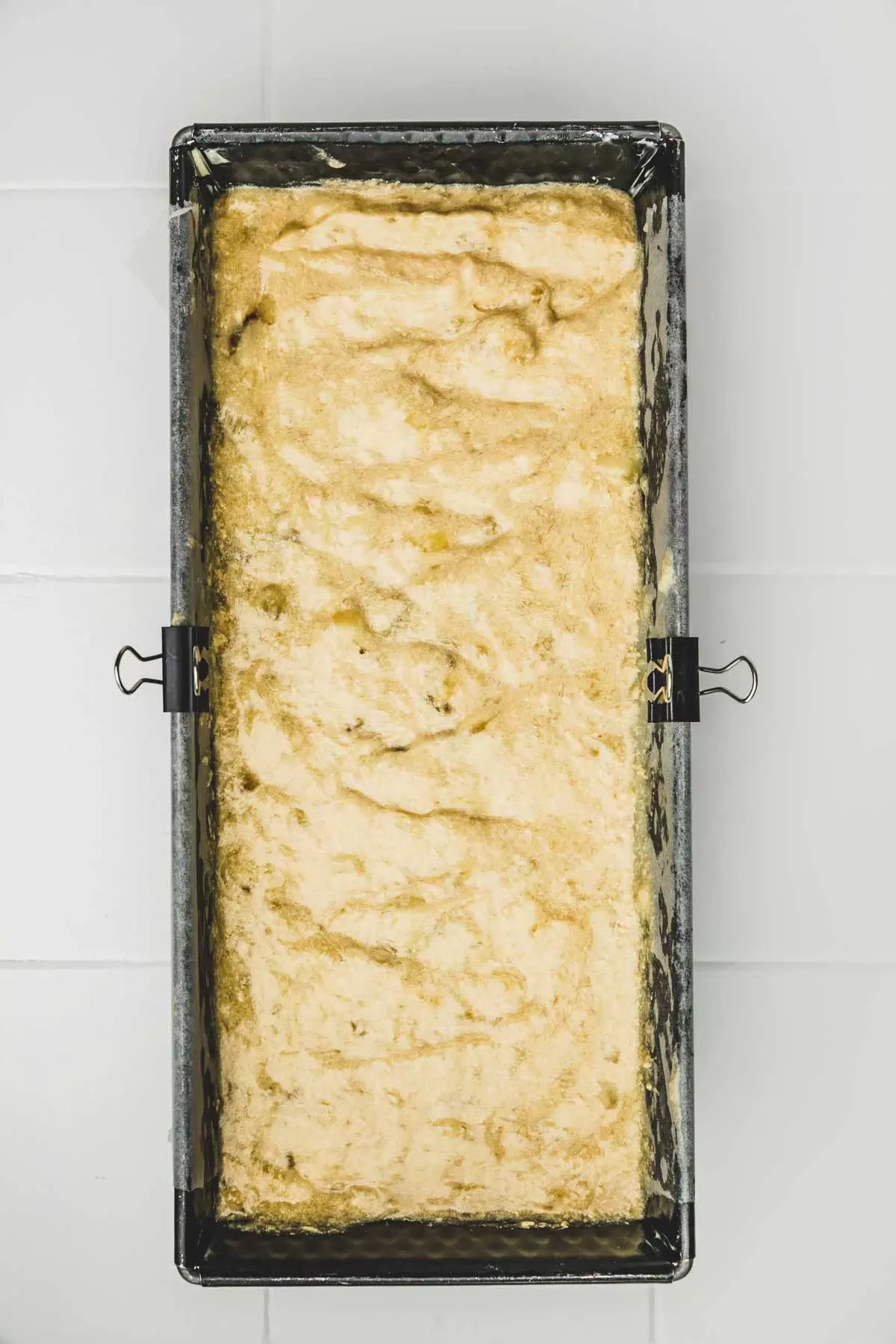 walnut banana bread batter in a loaf pan