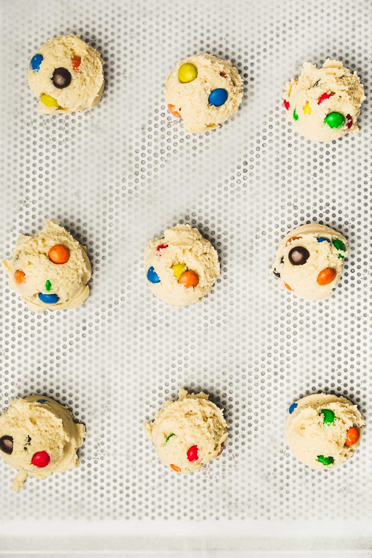 Ball of m&m's cookie dough on a baking sheet