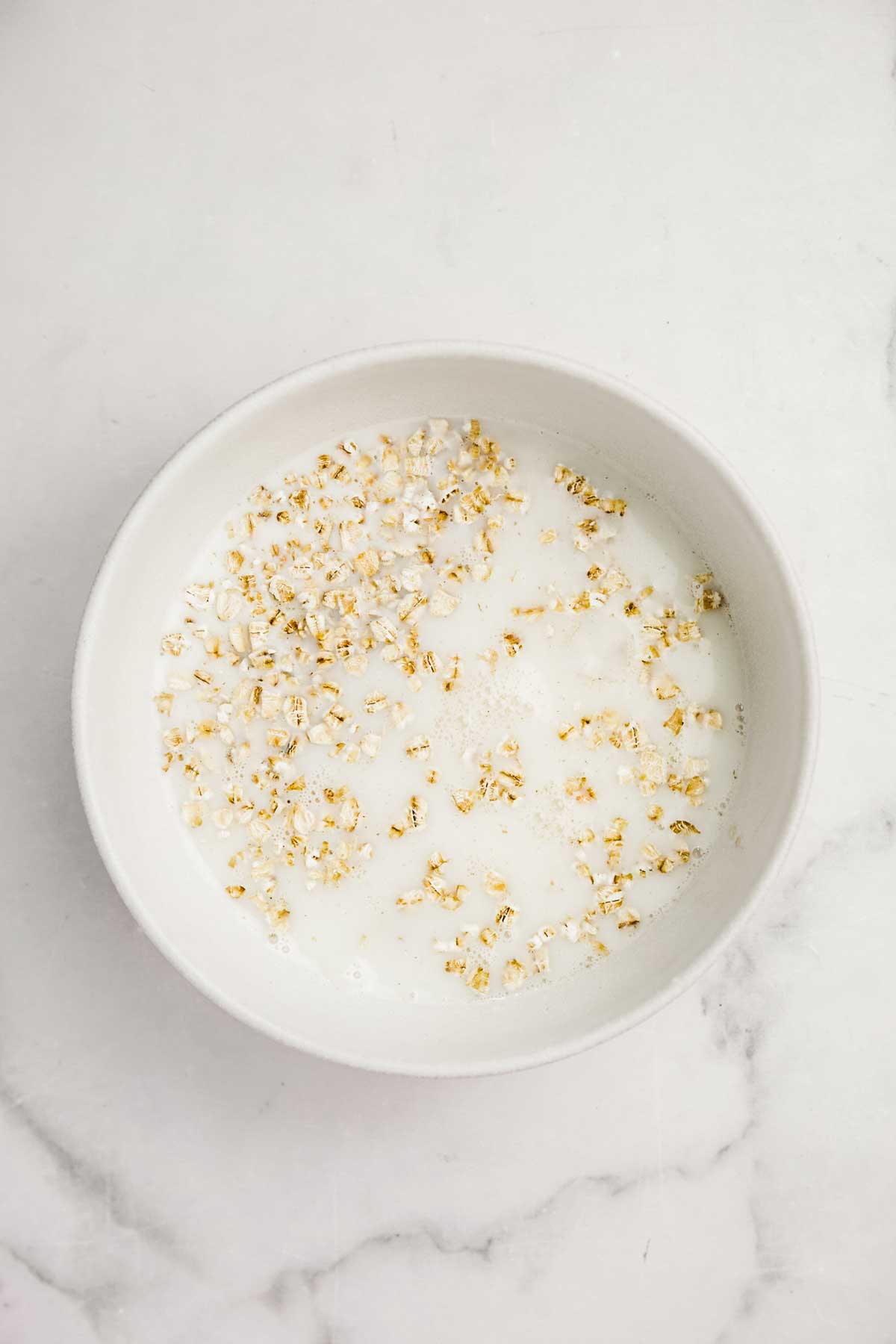 Bowl with rolled oats and milk