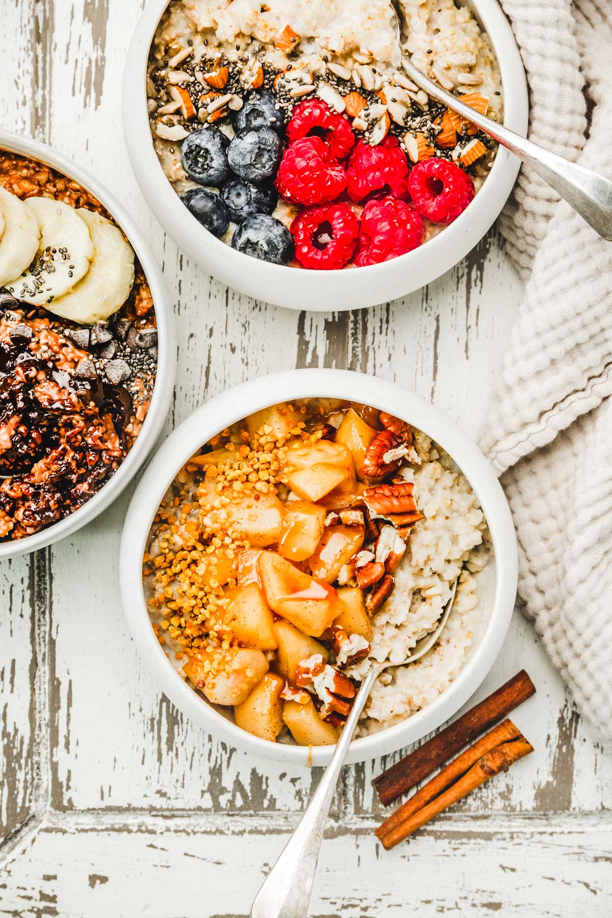 oats porridge bowls with fresh fruits and nut on a table