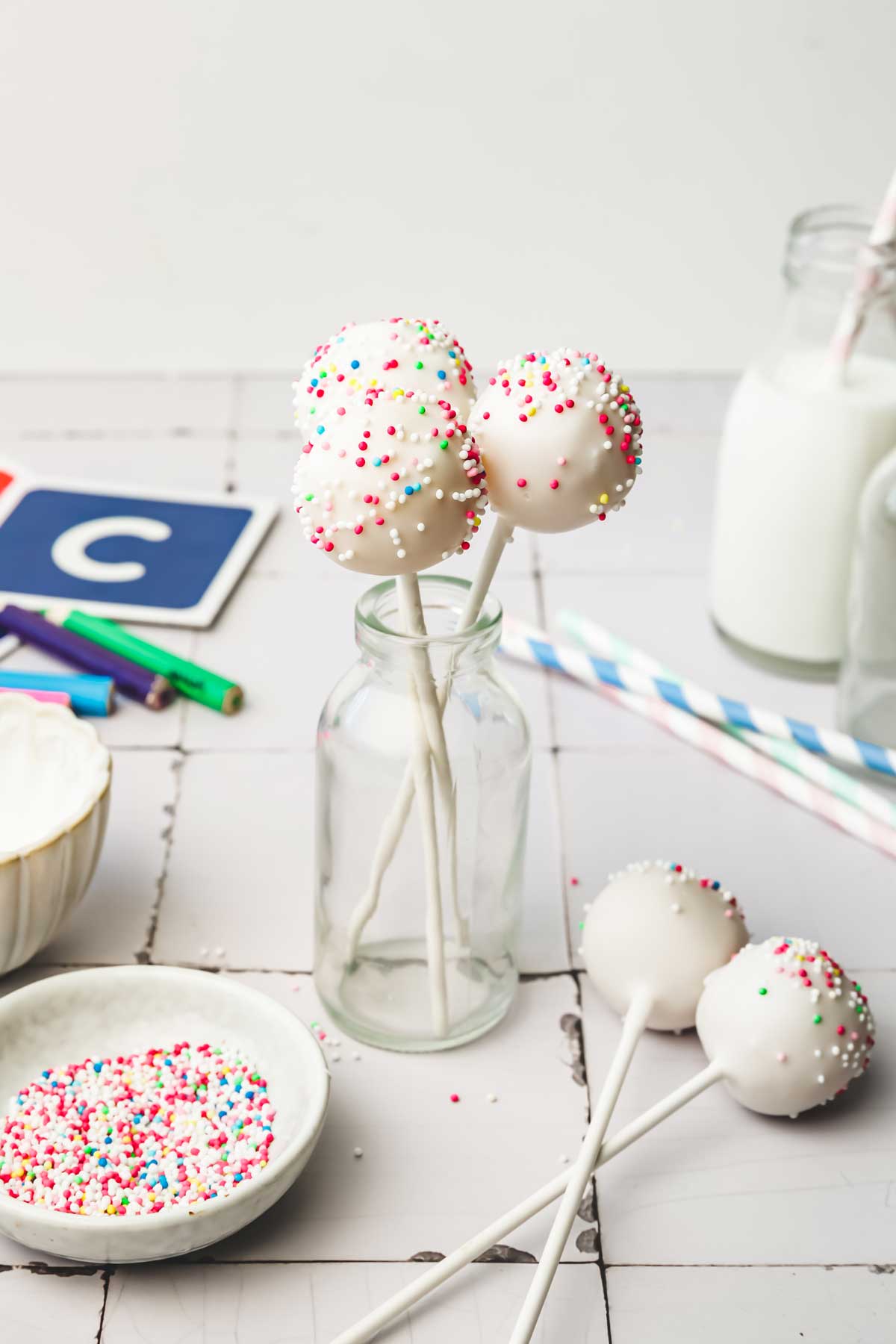 Cake pops on a table in a small glass bottle