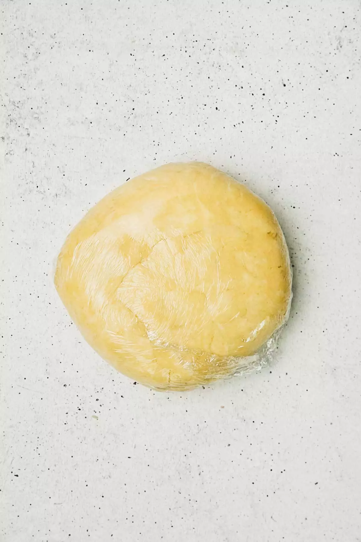 pie crust under a plastic wrap