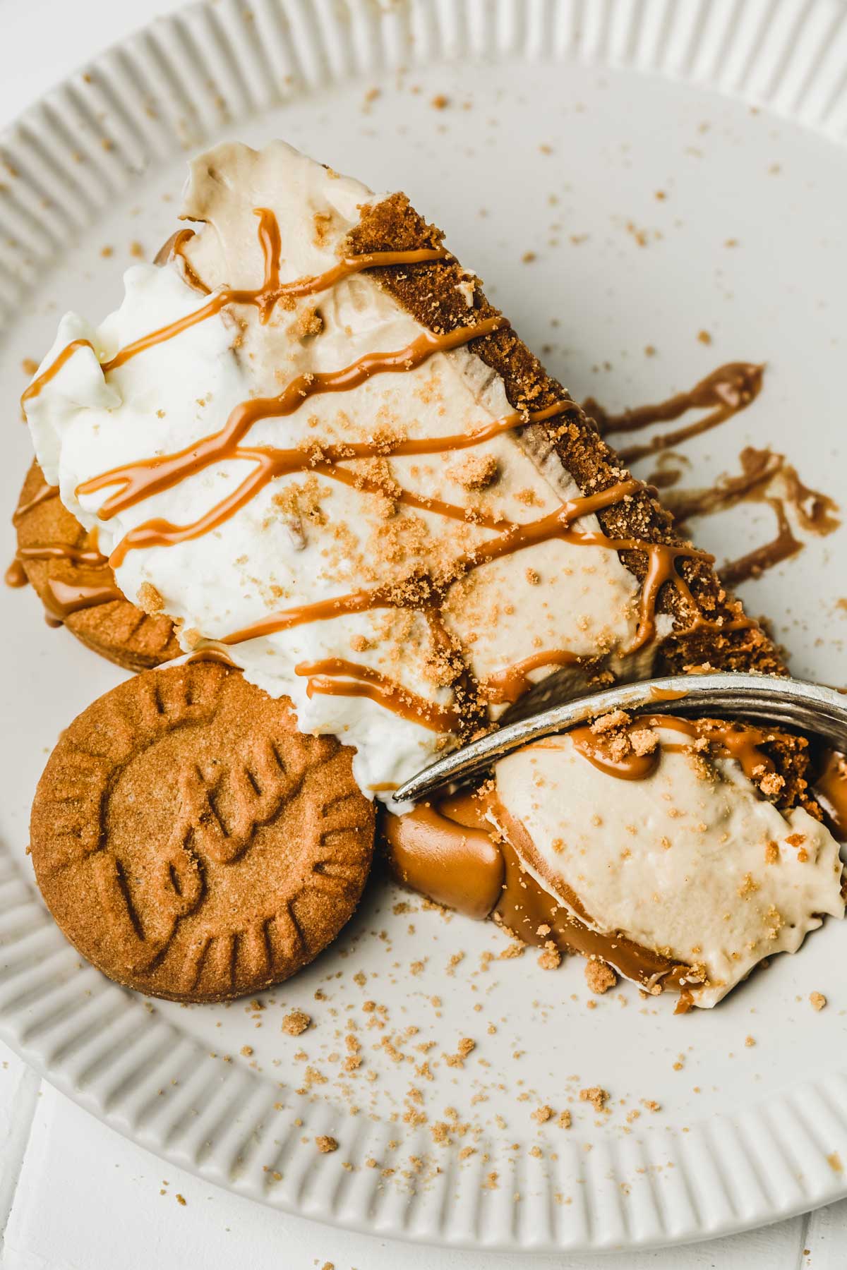 part de cheesecake aux spéculoos coupé dans une assiette