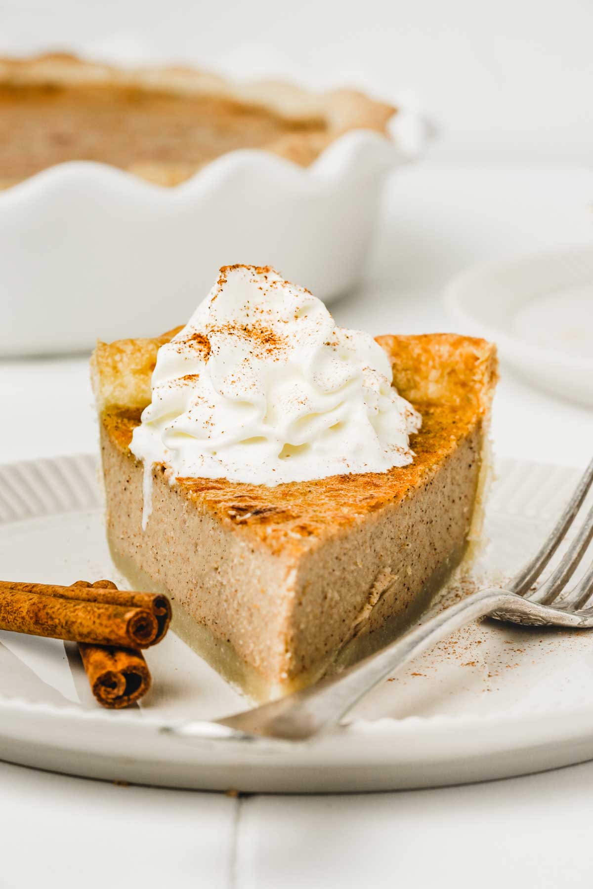 Cinnamon pie slice with whipped cream on a plate