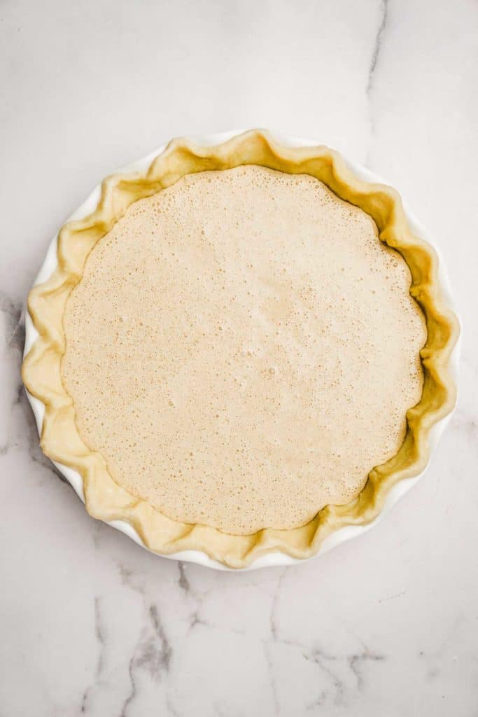 Unbaked cinnamon custard filling in a homemade pie crust