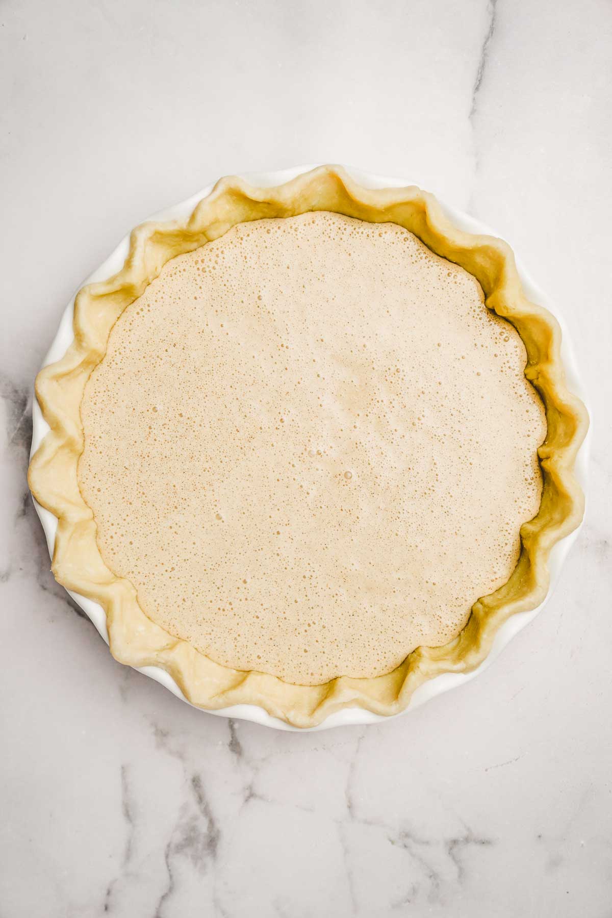 Pie dish with pie crust and cinnamon filling