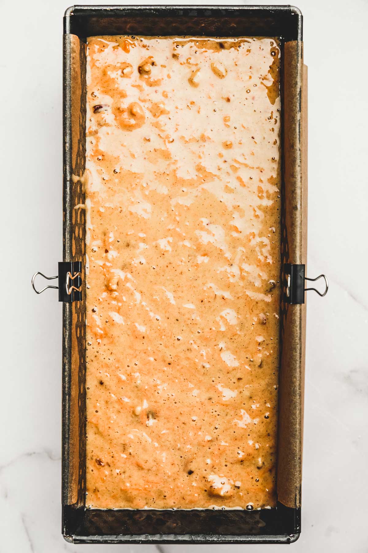 loaf pan with carrot bread batter