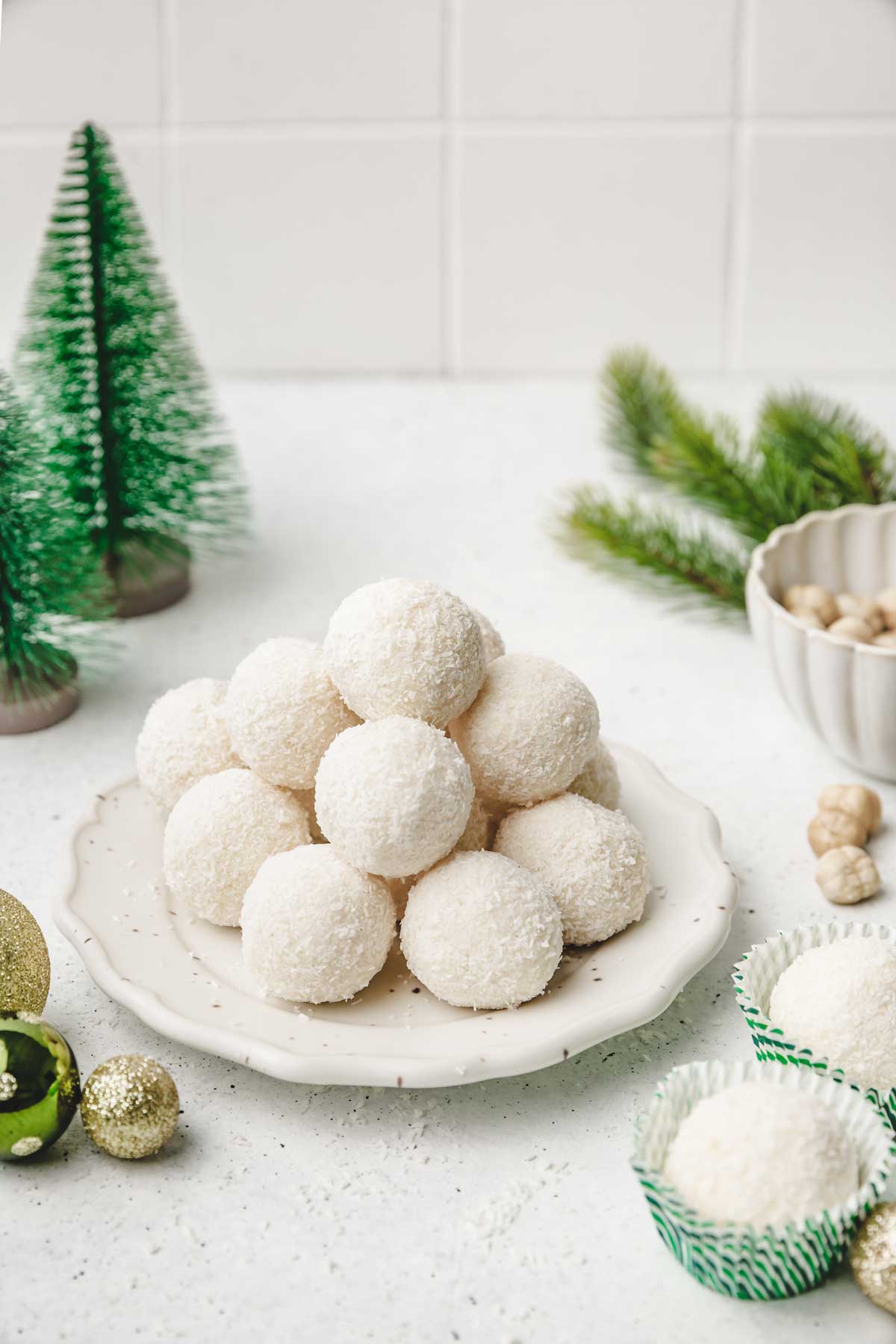 coconut balls on a plate on a dessert table