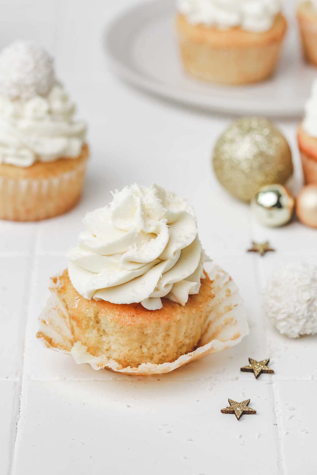 Coconut cupcakes with coconut frosting on a table