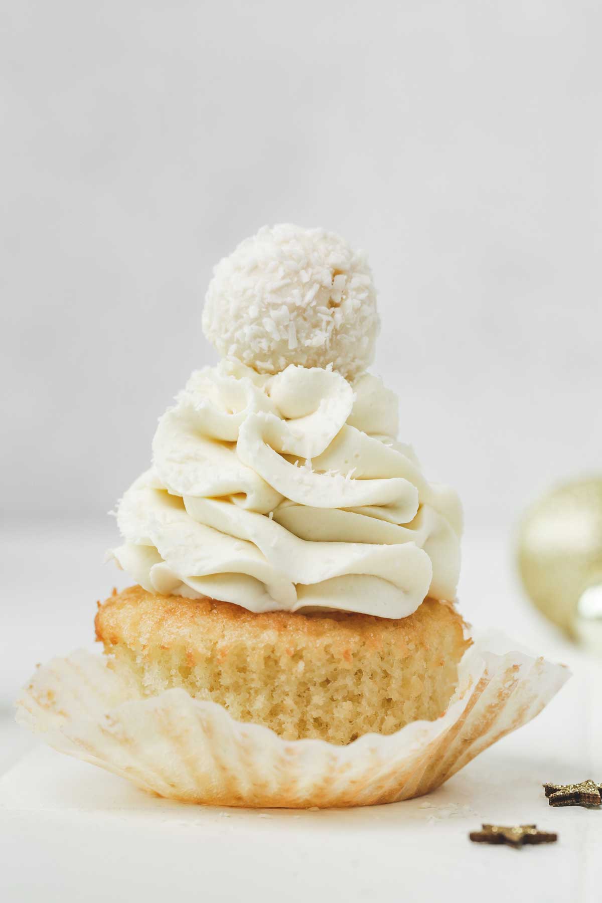 coconut cupcakes topped with coconut ganache and raffaello