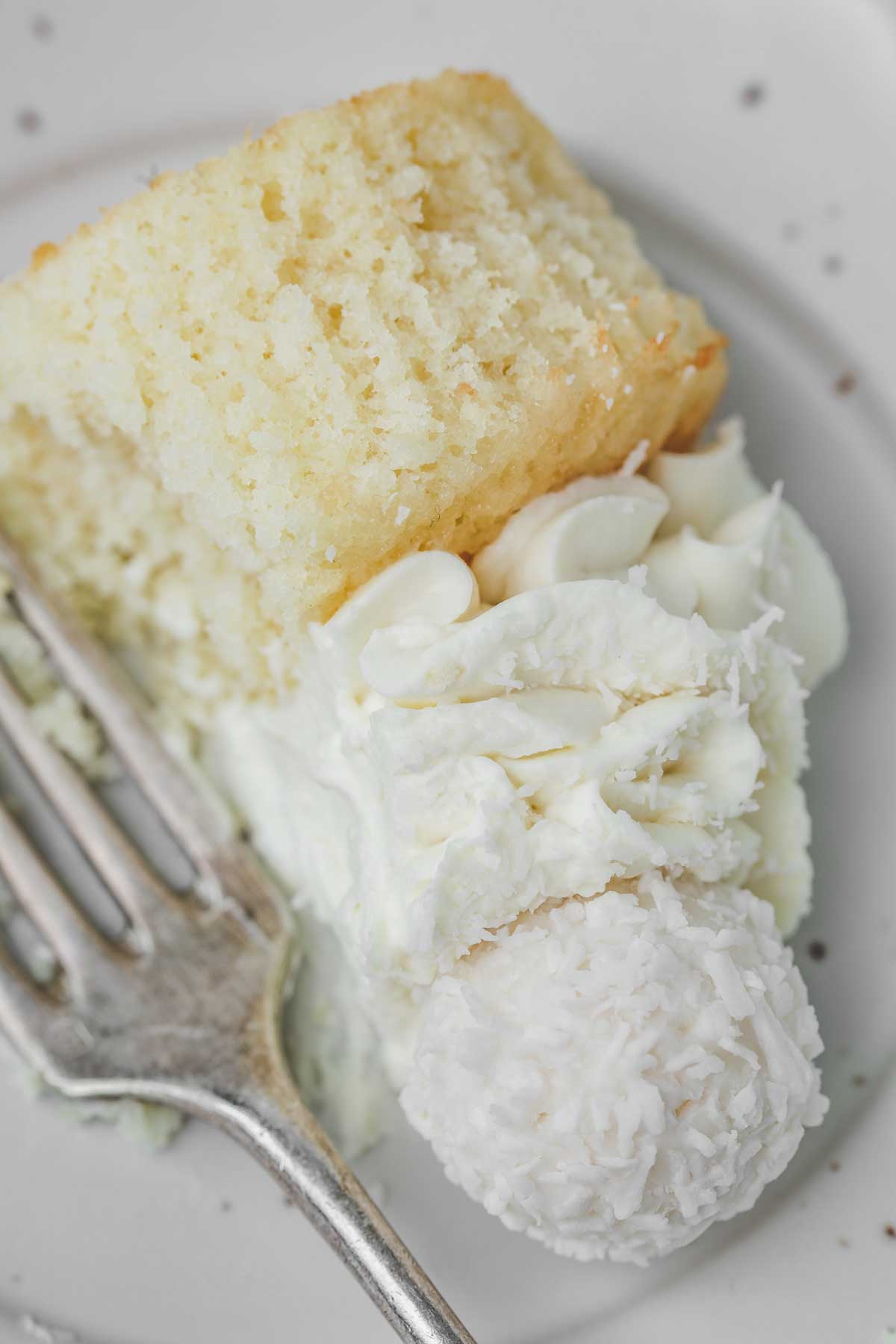 coconut cupcakes on a plate with a fork