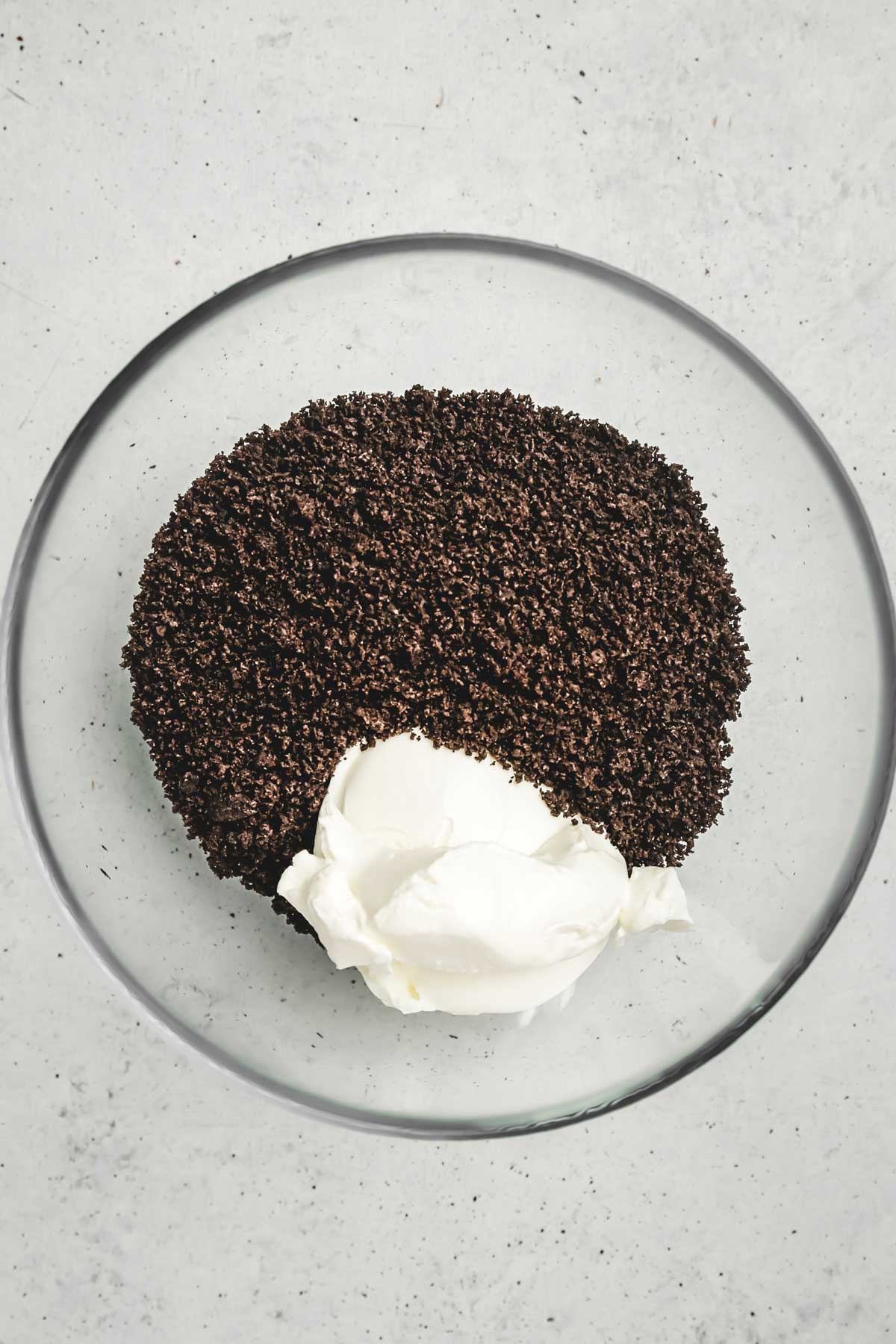 Crushed Oreo cookies and cream cheese mixture in bowl