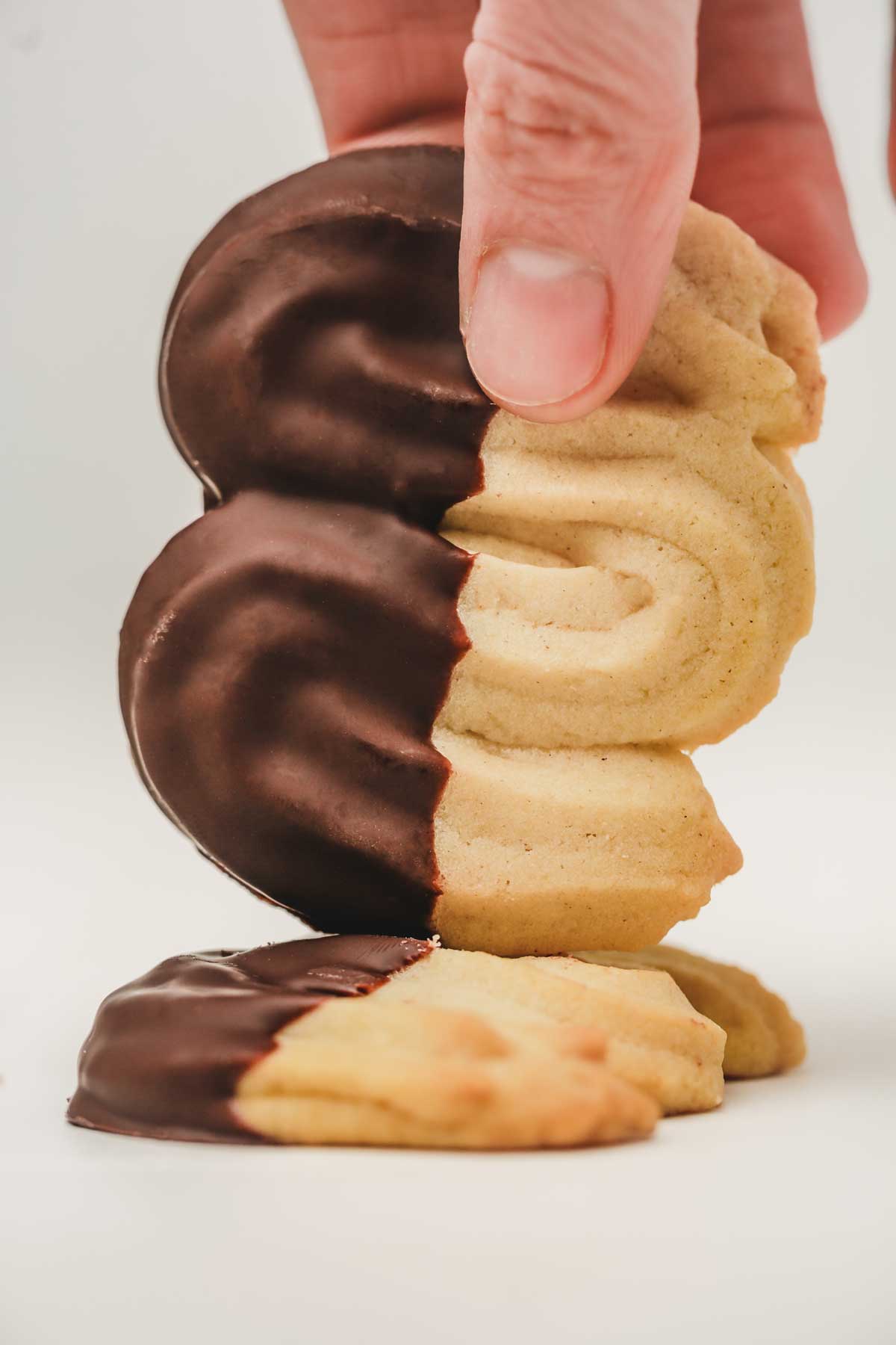 spritzback cookies on a hand