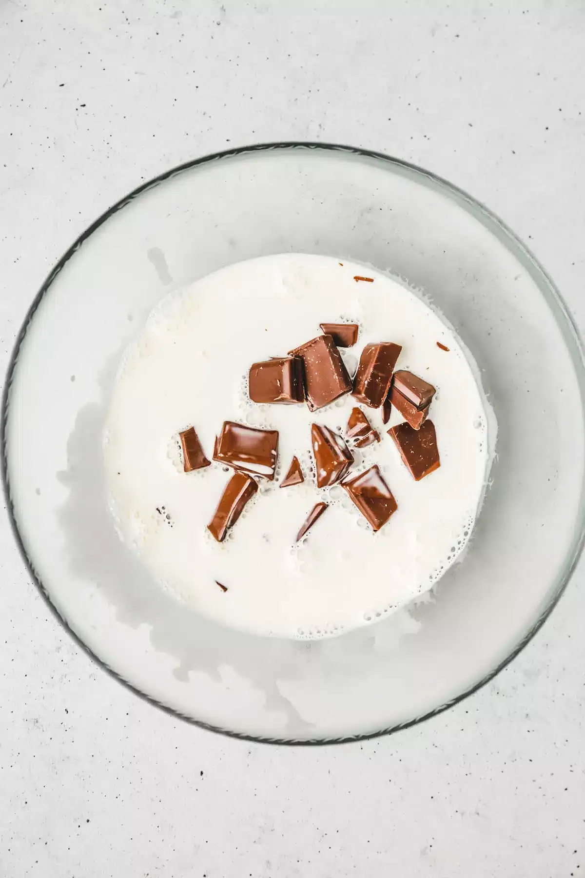 Bowl with chopped chocolate and cream