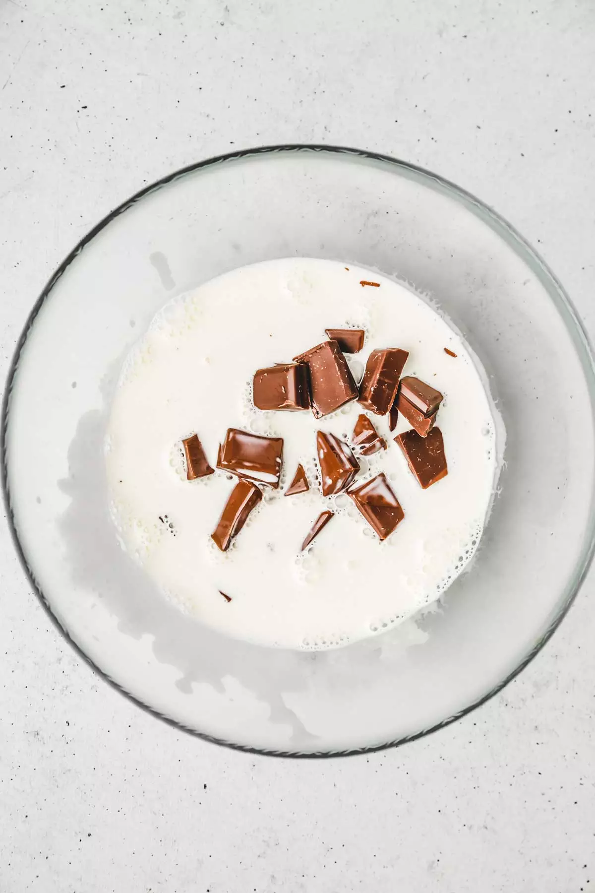 Bowl with chopped chocolate and cream