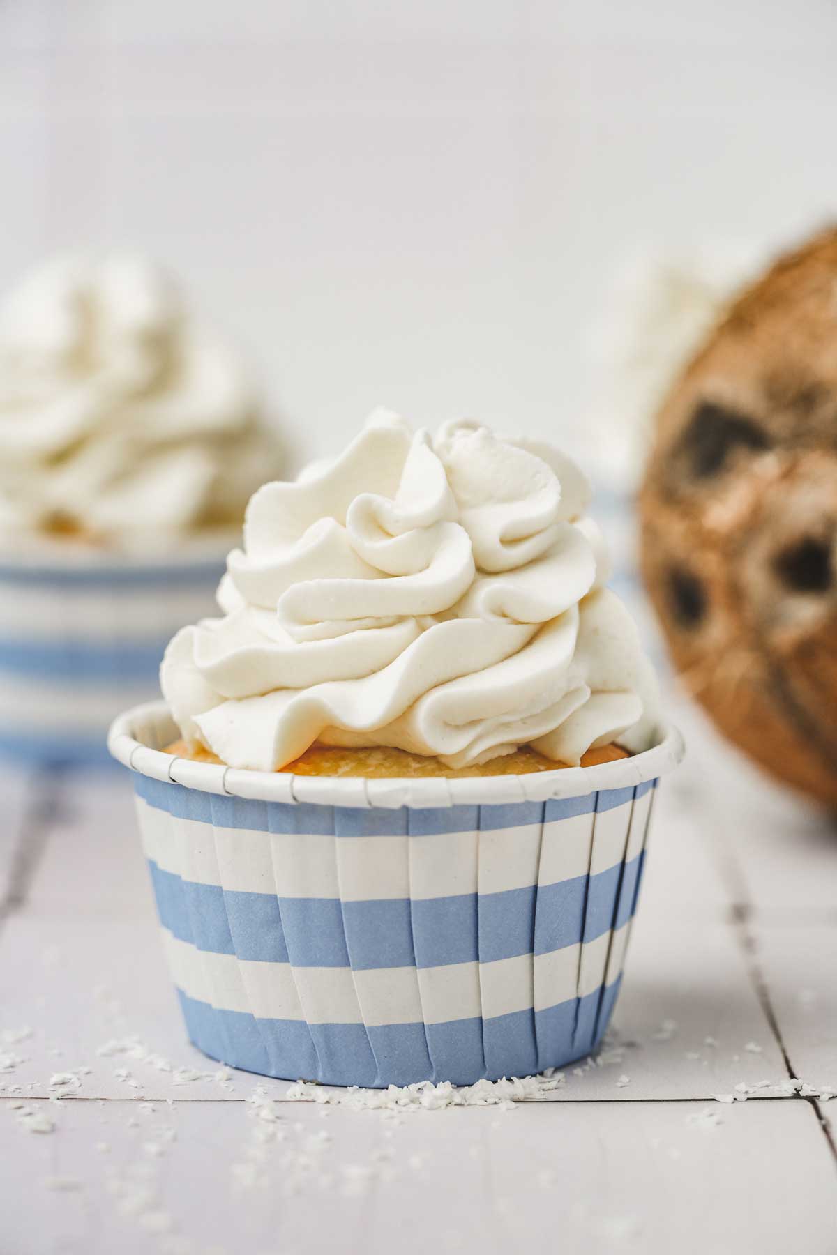 one cupcake topped with a coconut frosting