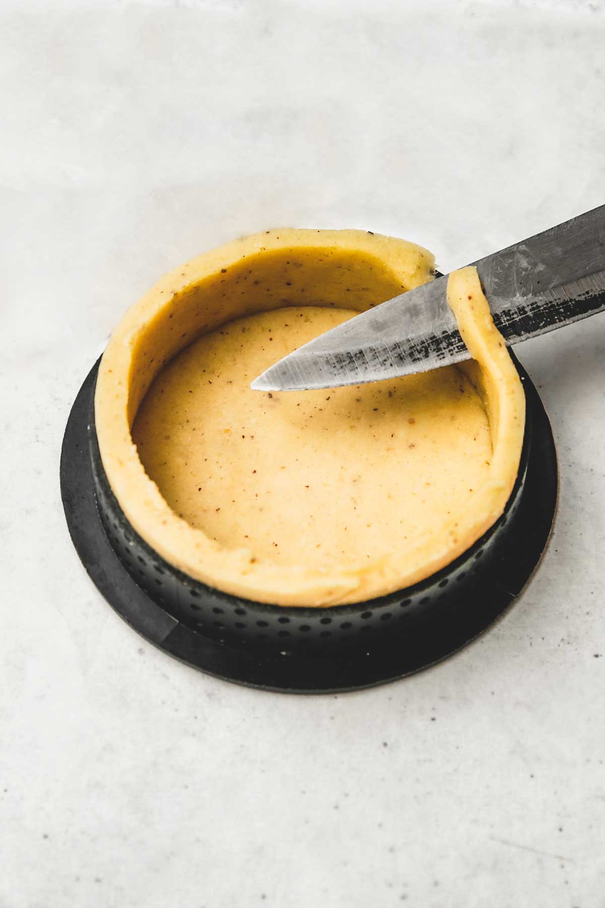 perforated tartlet ring with pastry dough