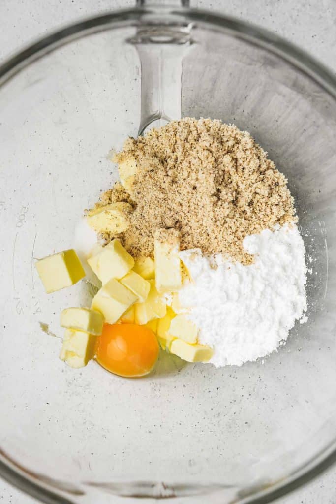 mixing bowl with egg butter almond meal and powdered sugar