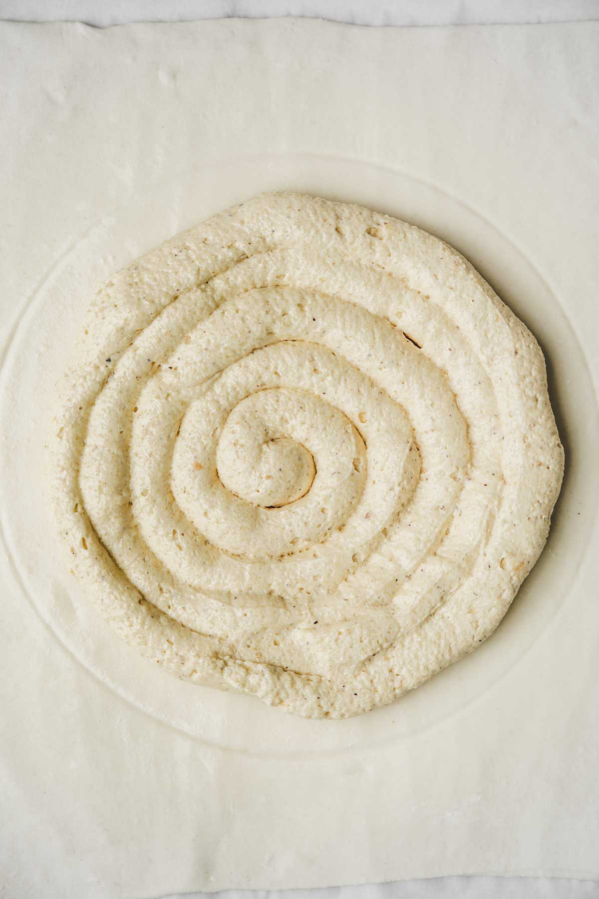 Roll out puff pastry filled with almond cream