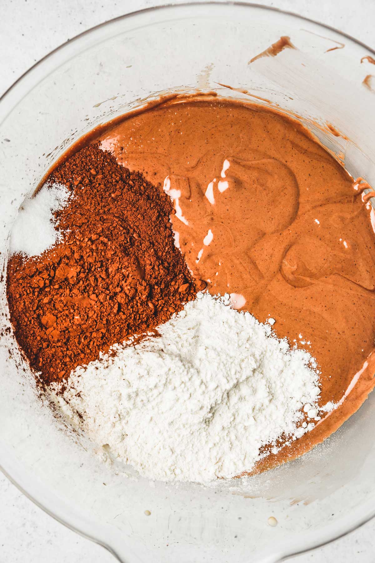 large bowl with brownie batter and dry ingredients